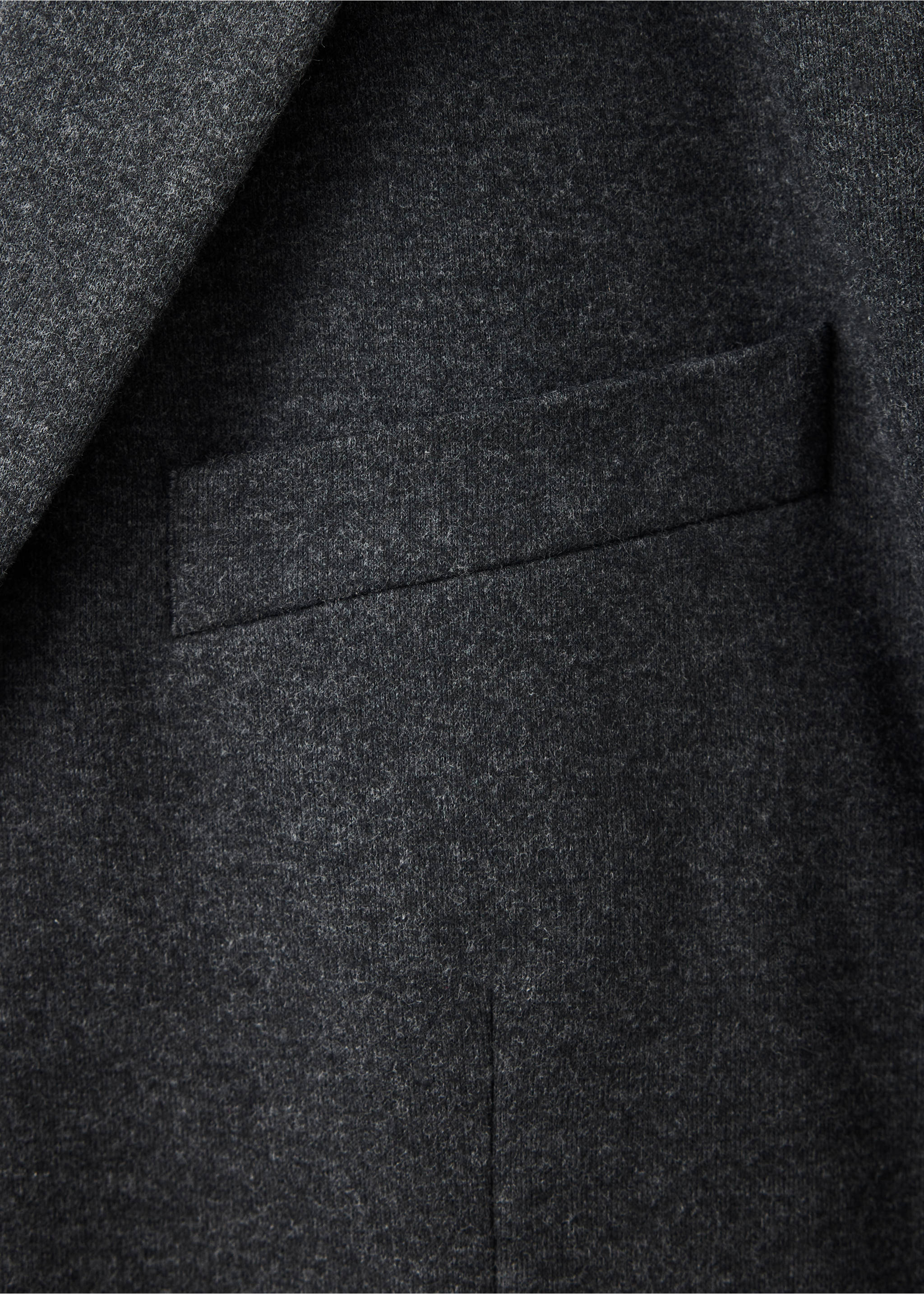 Close-up of the dark grey fabric and chest pocket of a blazer., Grey. Ref: 37087885-00.