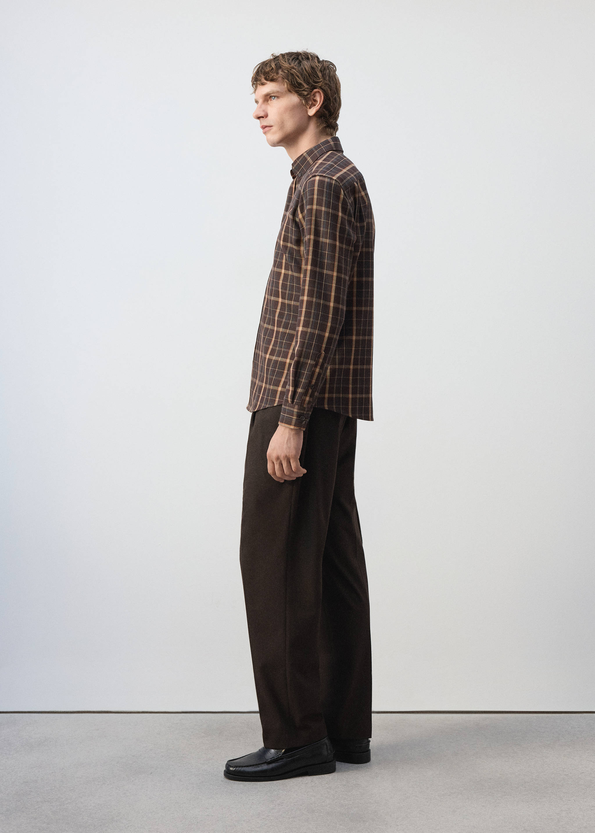 Brown and tan plaid overshirt with a classic collar and long sleeves.