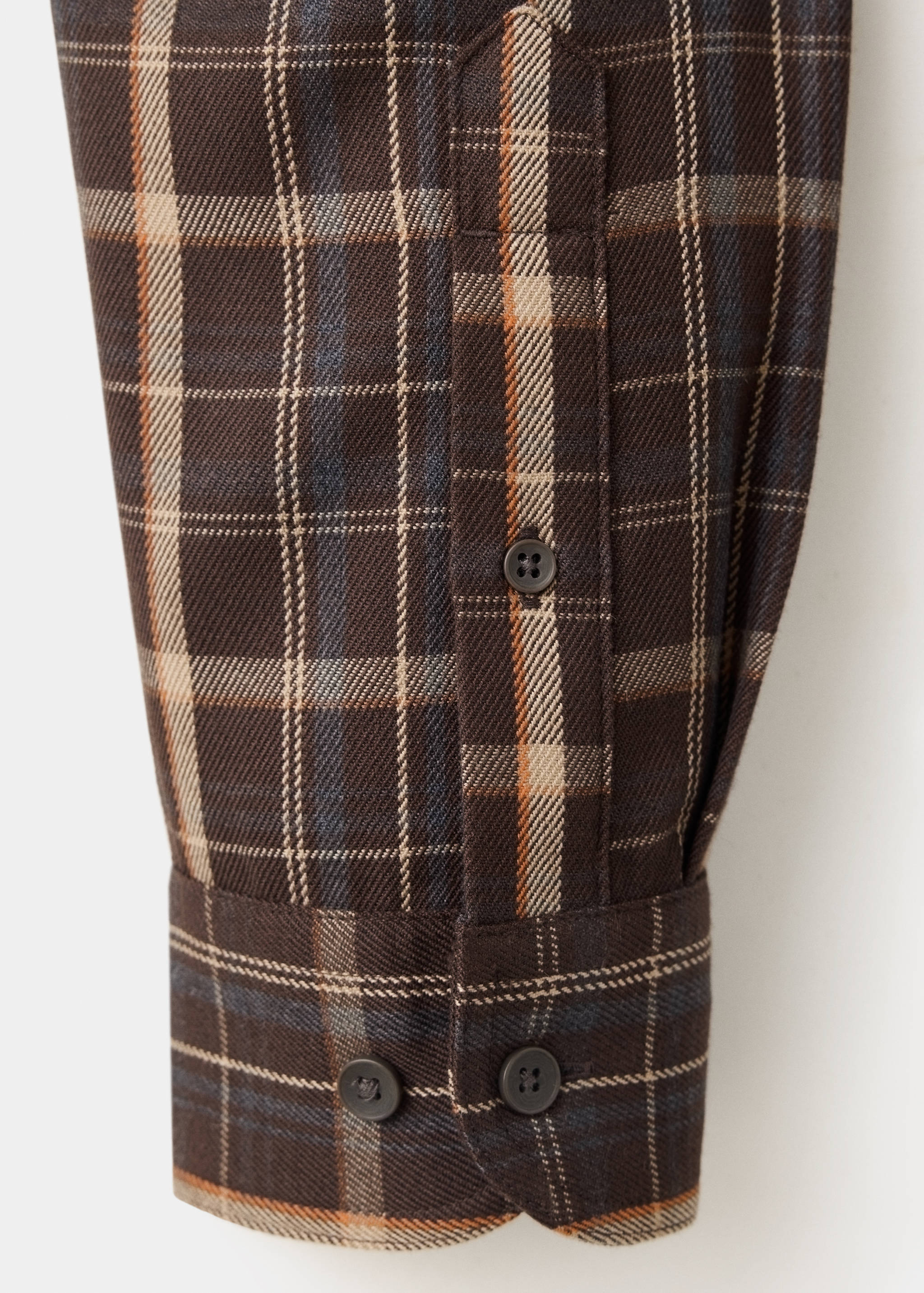 Brown plaid overshirt fabric and buttoned cuff detail.
