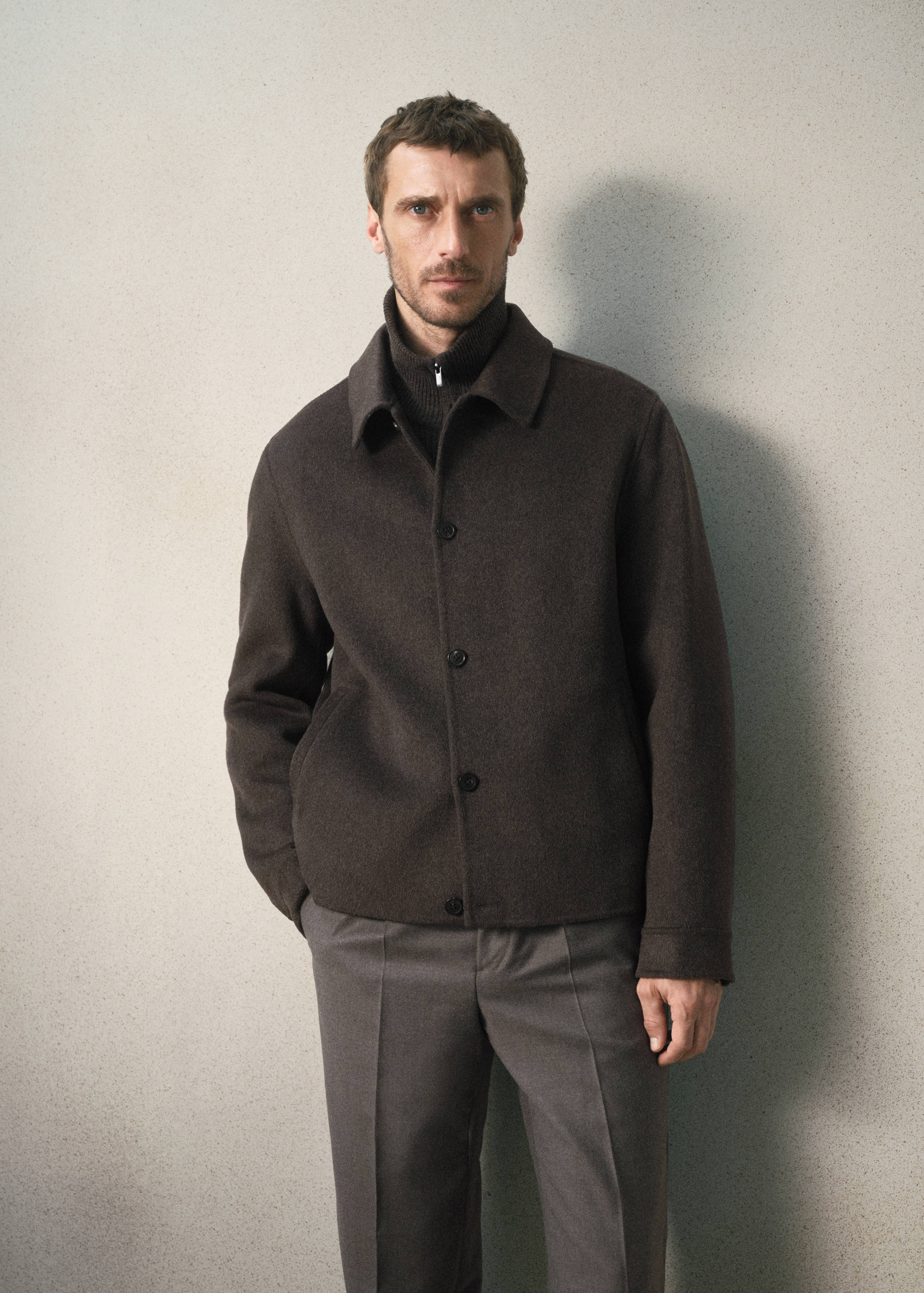 Dark brown jacket with a shirt collar and button fastening.