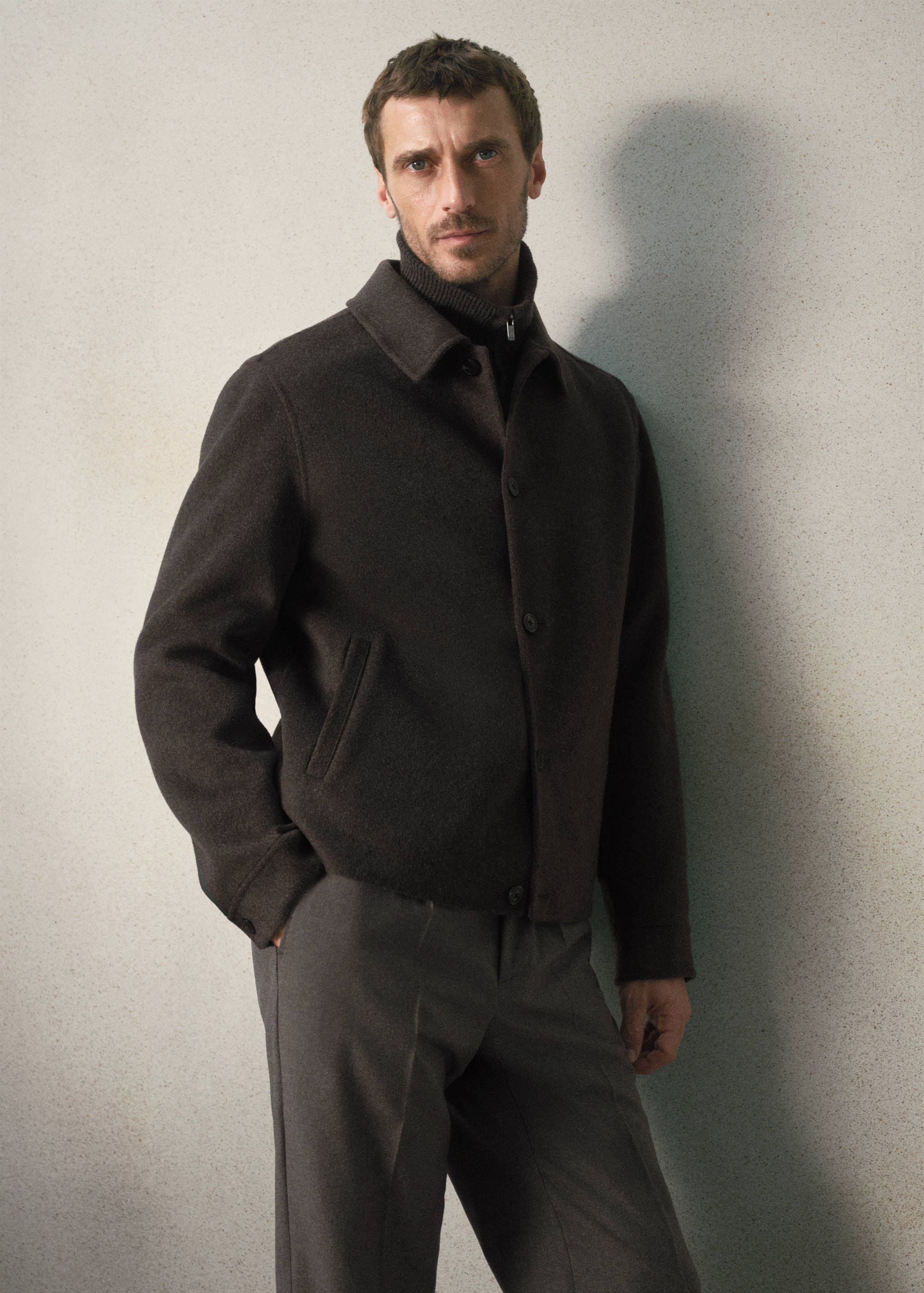 Dark brown jacket with classic collar and front buttons.