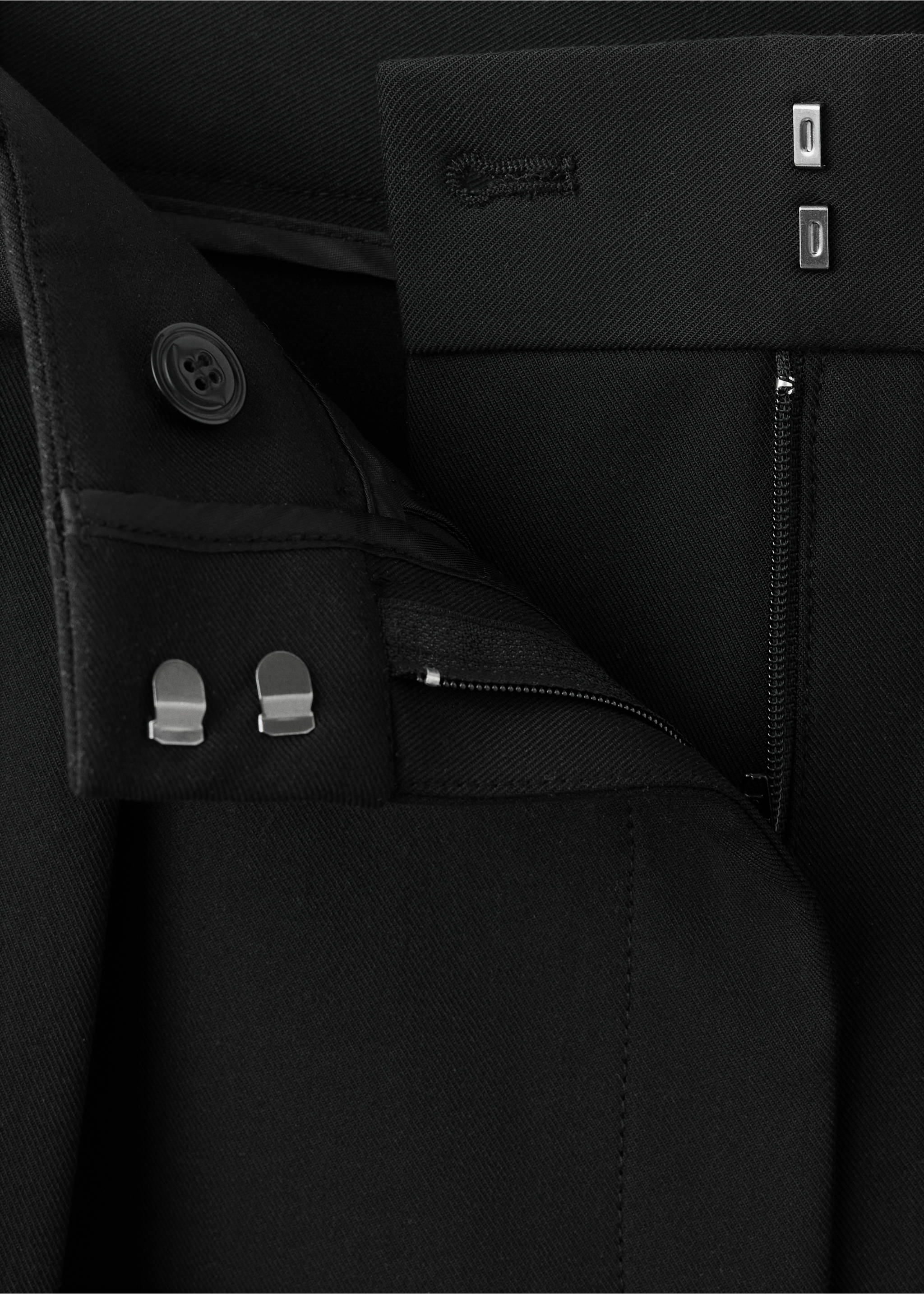 Close-up of black trousers showing the waistband, zip fly and hook-and-eye closure., Black. Ref: 37087898-00.