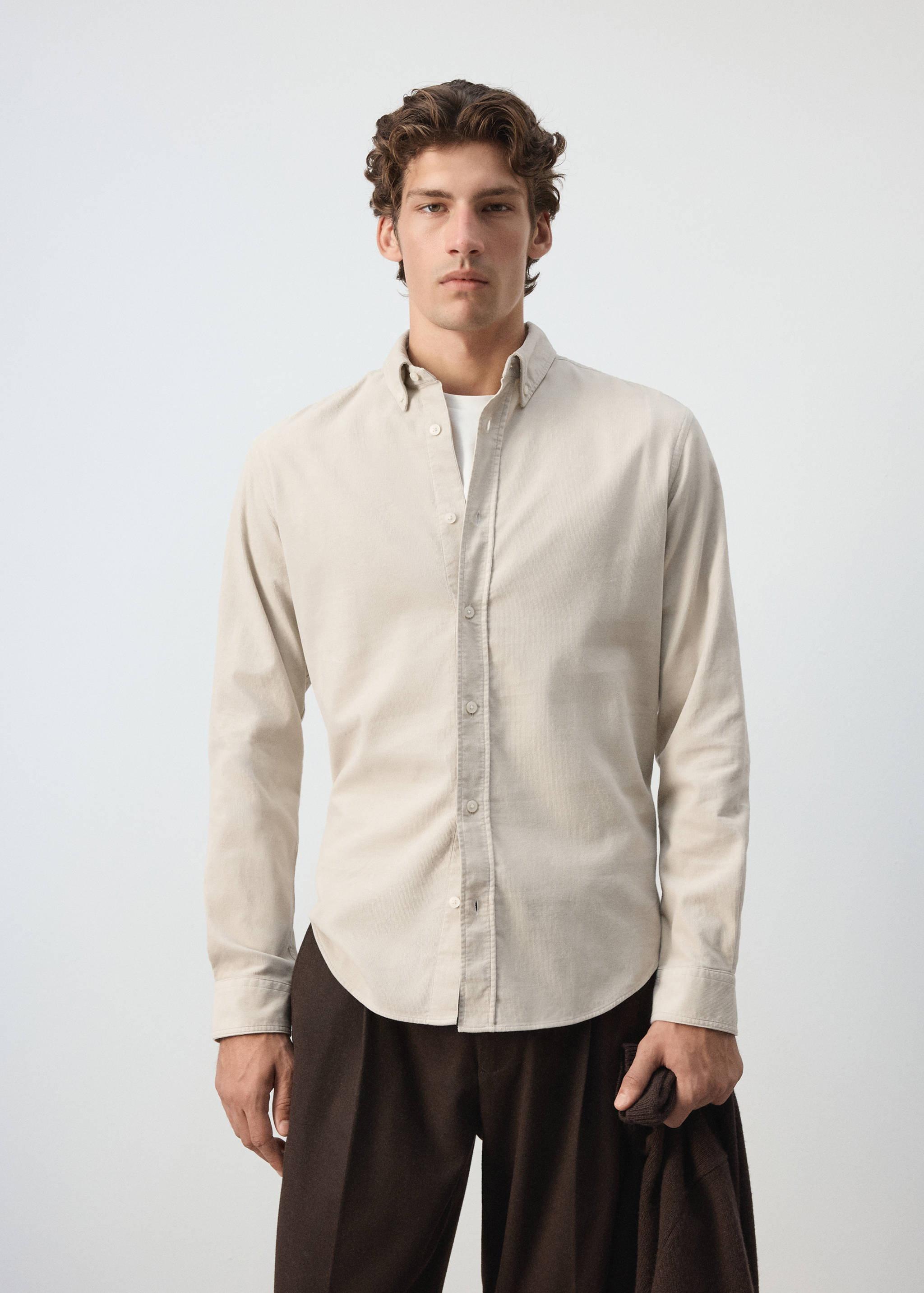 Light beige long-sleeved button-down shirt with a button-down collar.