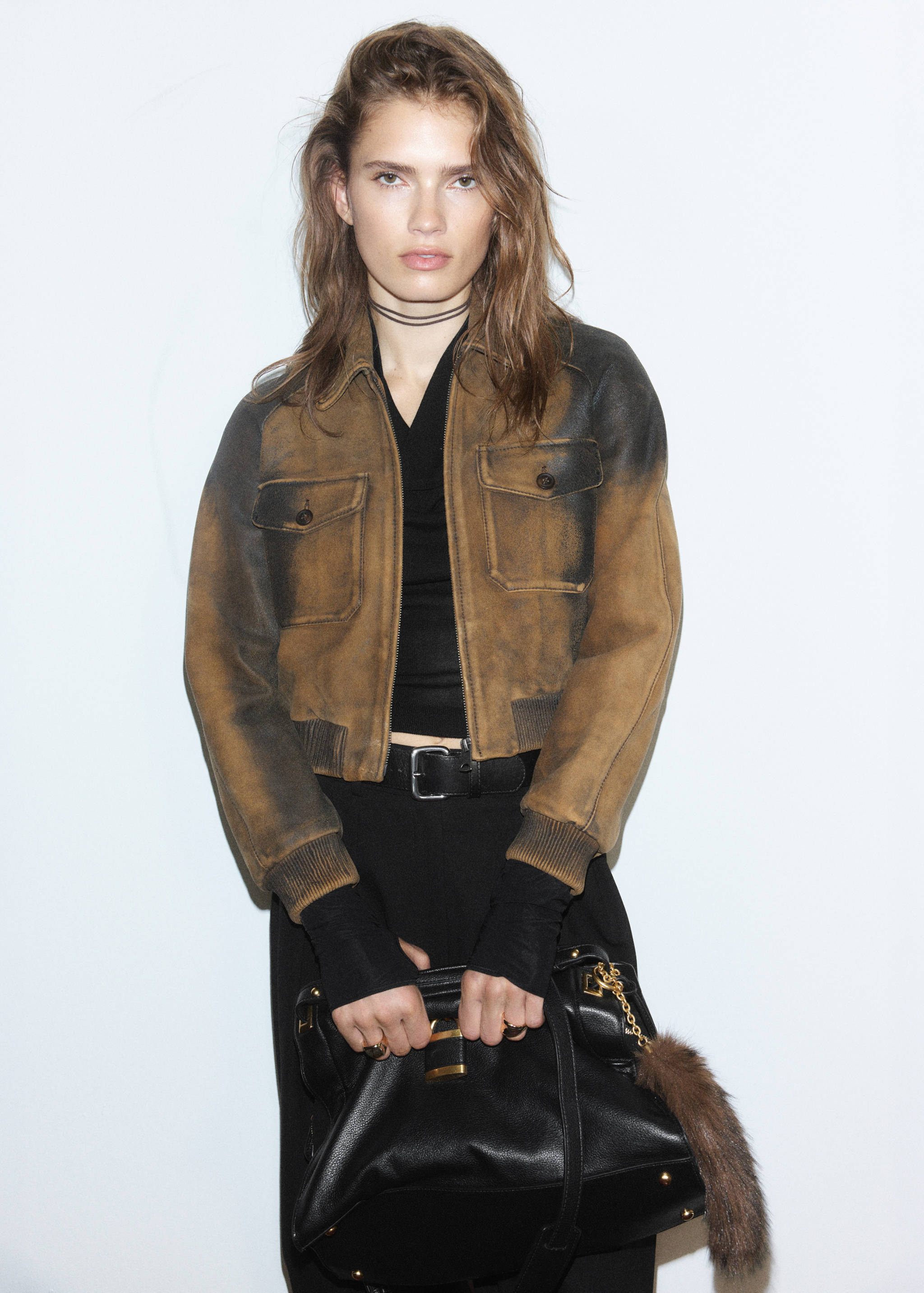 Brown distressed leather jacket with zip fastening and flap chest pockets.