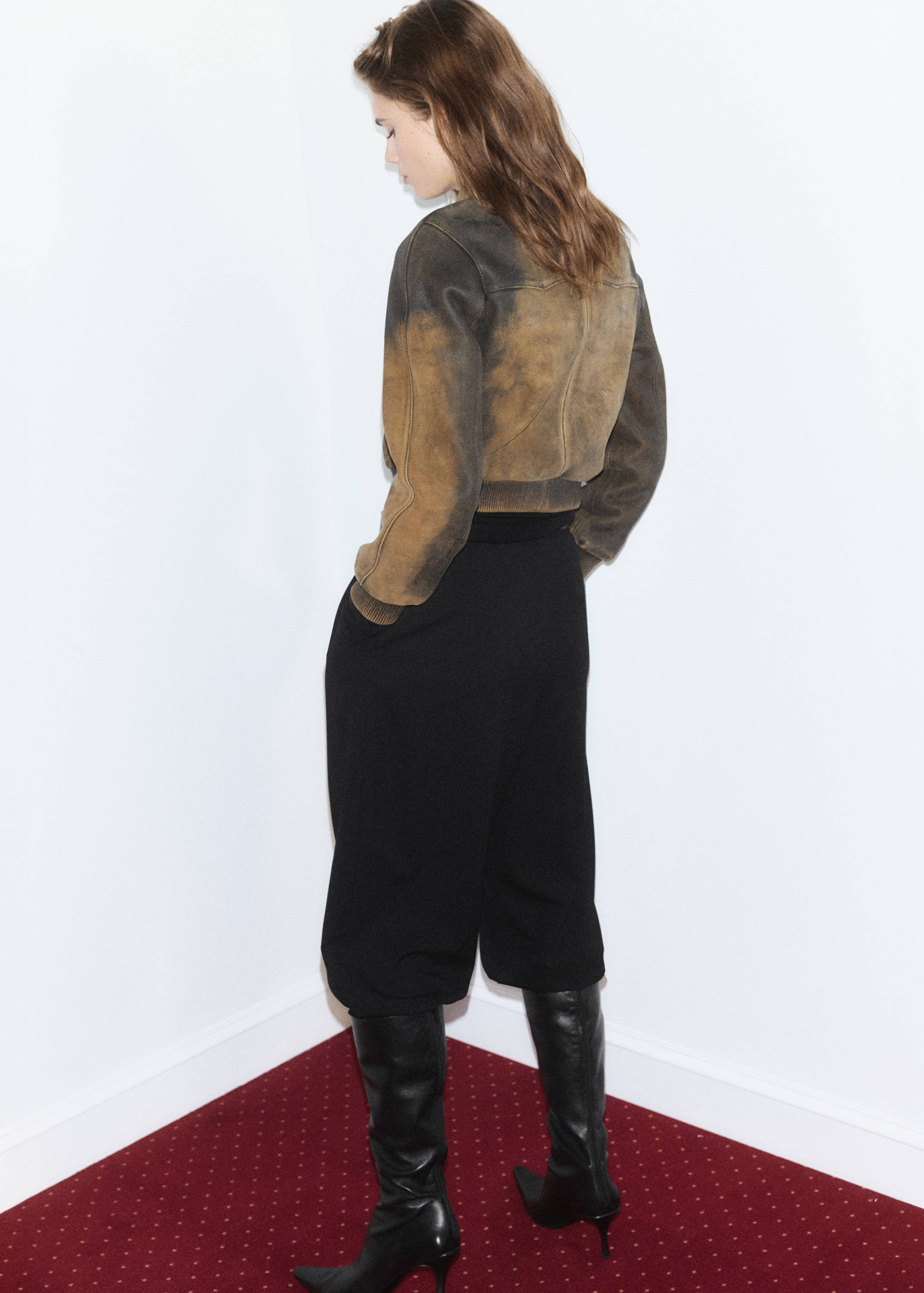 Brown and black distressed jacket shown from the back.
