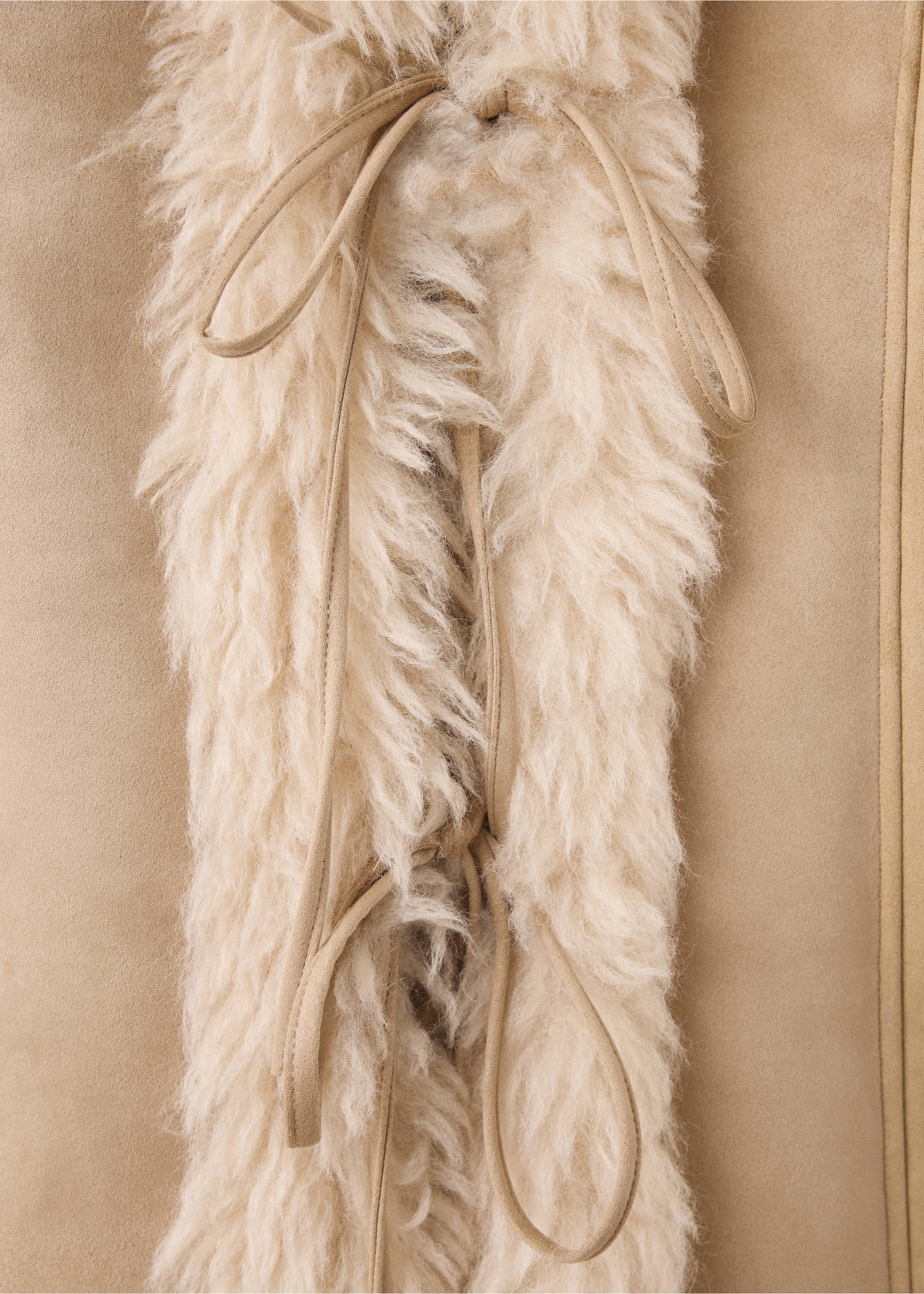 Close-up of a beige jacket featuring cream faux-shearling trim and suede ties., Beige. Ref: 37087907-00.