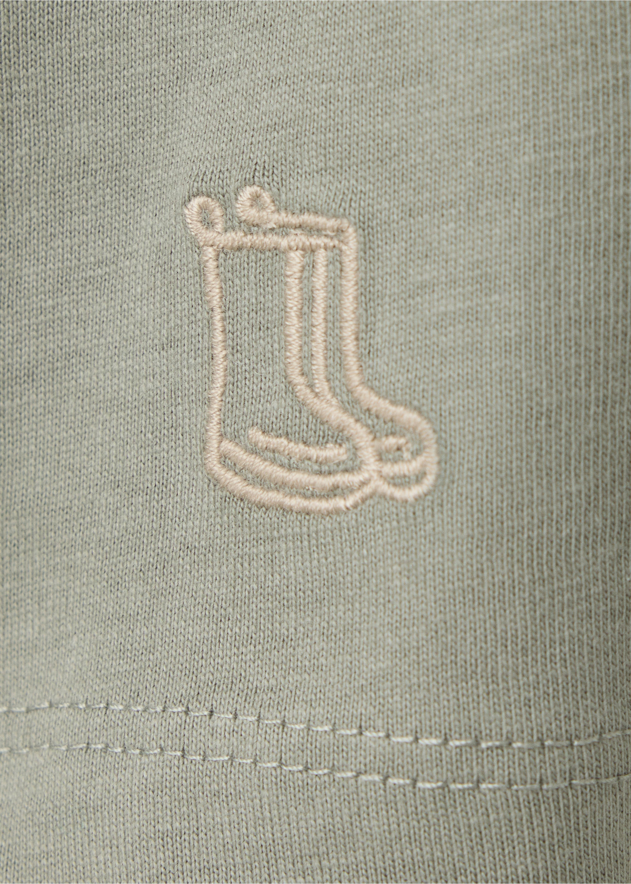 Sage green kids' polo fabric detail showing a rain boot embroidery., Medium Green. Ref: 37087919-00.