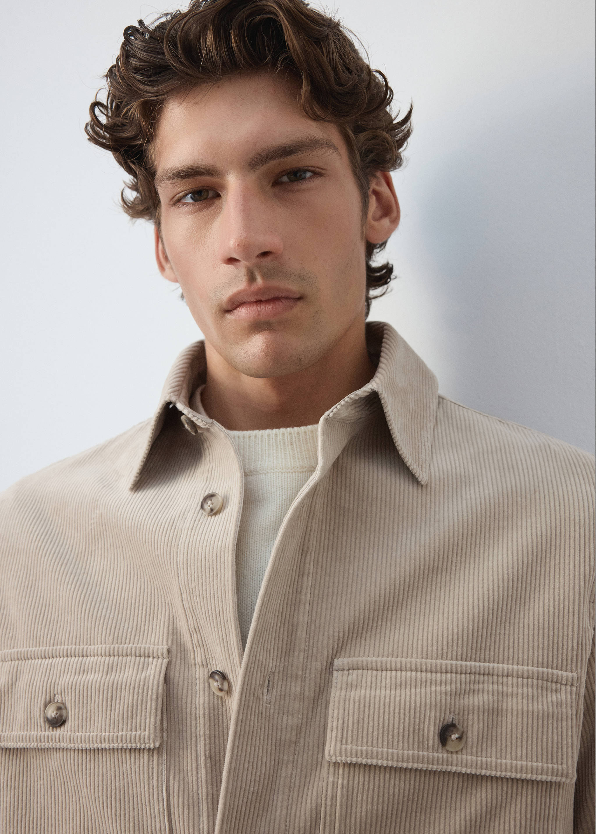 Light beige corduroy overshirt with buttoned chest pockets and collar.