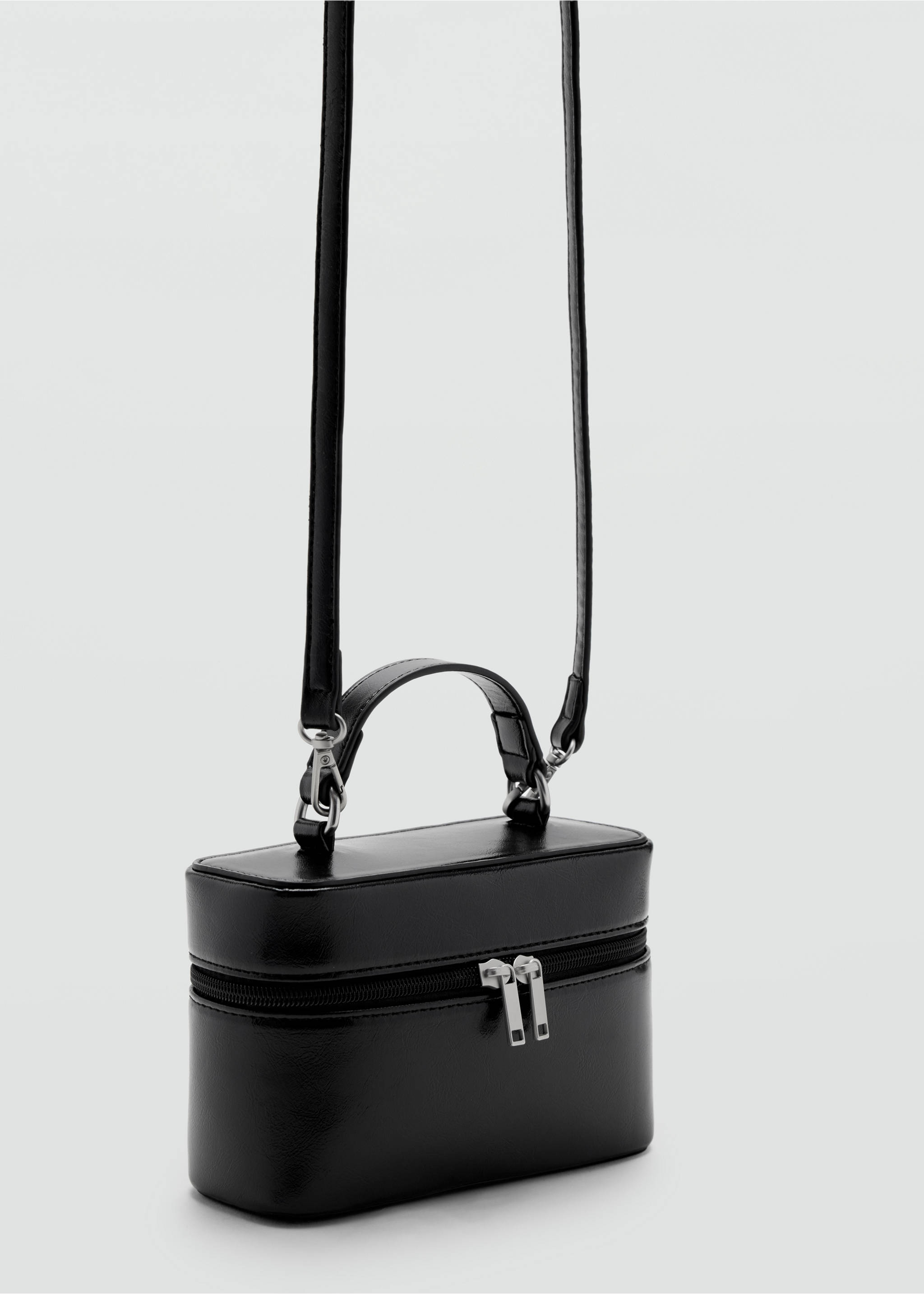 Black structured mini vanity bag with a top handle and silver-tone zip., Black. Ref: 37087930-00.