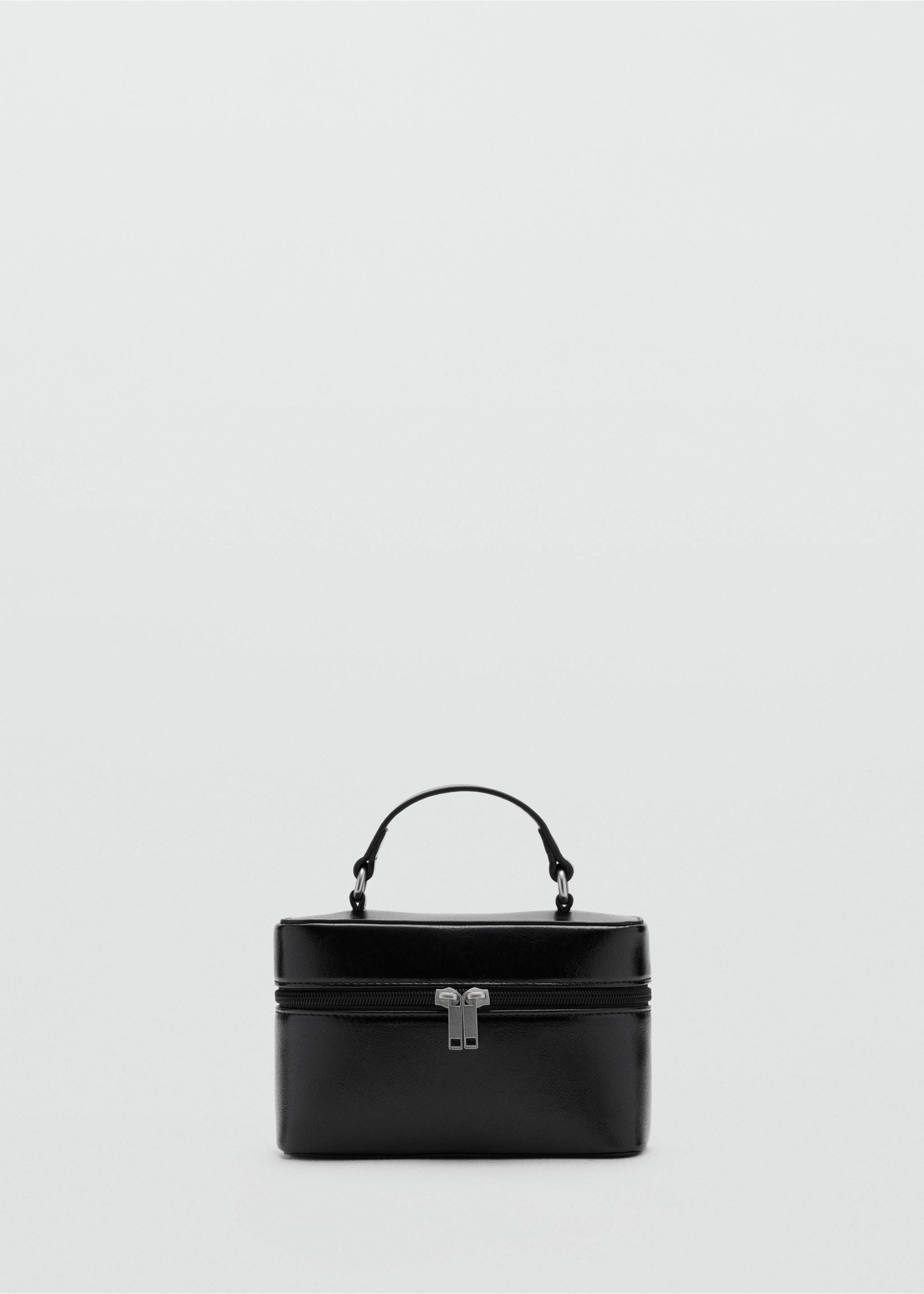 Black structured mini vanity bag with a top handle and silver-tone zip closure., Black. Ref: 37087930-00.