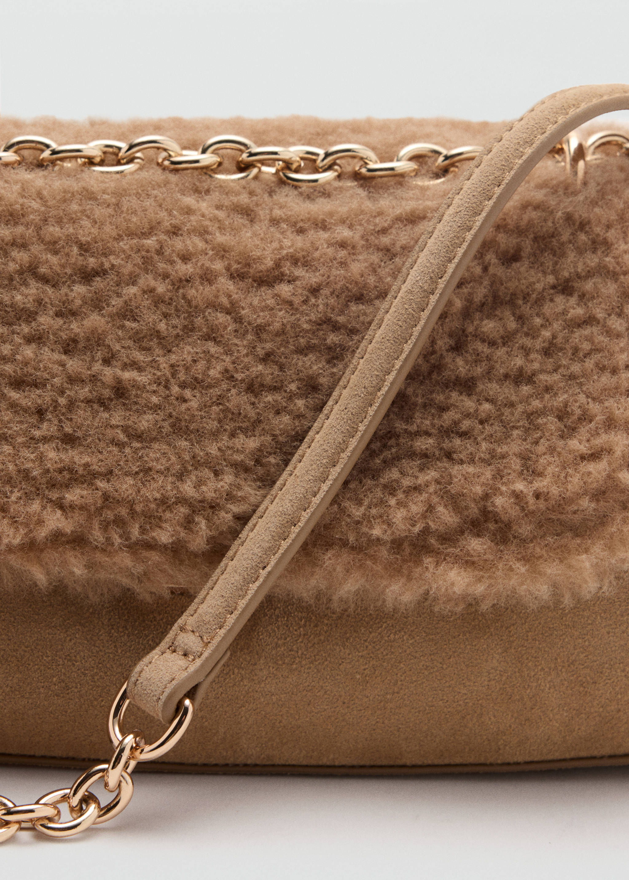 Brown faux-shearling shoulder bag detail with gold chain.