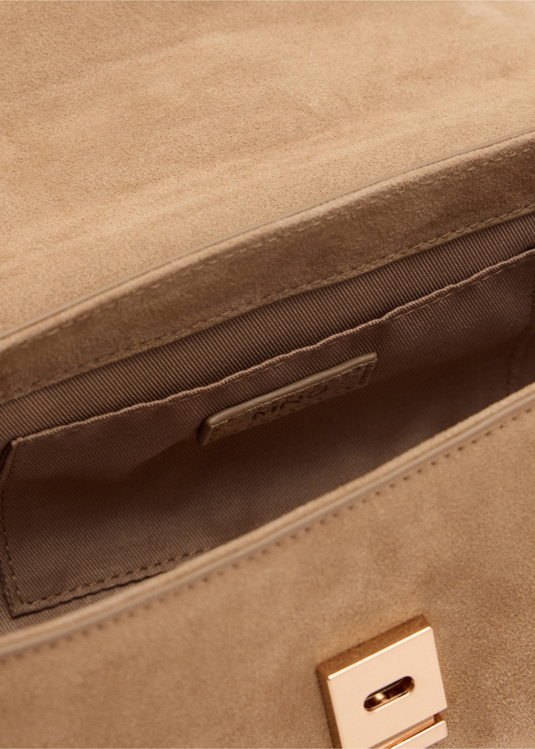 Close-up of the interior and metallic clasp of a brown suede shoulder bag., Medium Brown. Ref: 37087933-00.