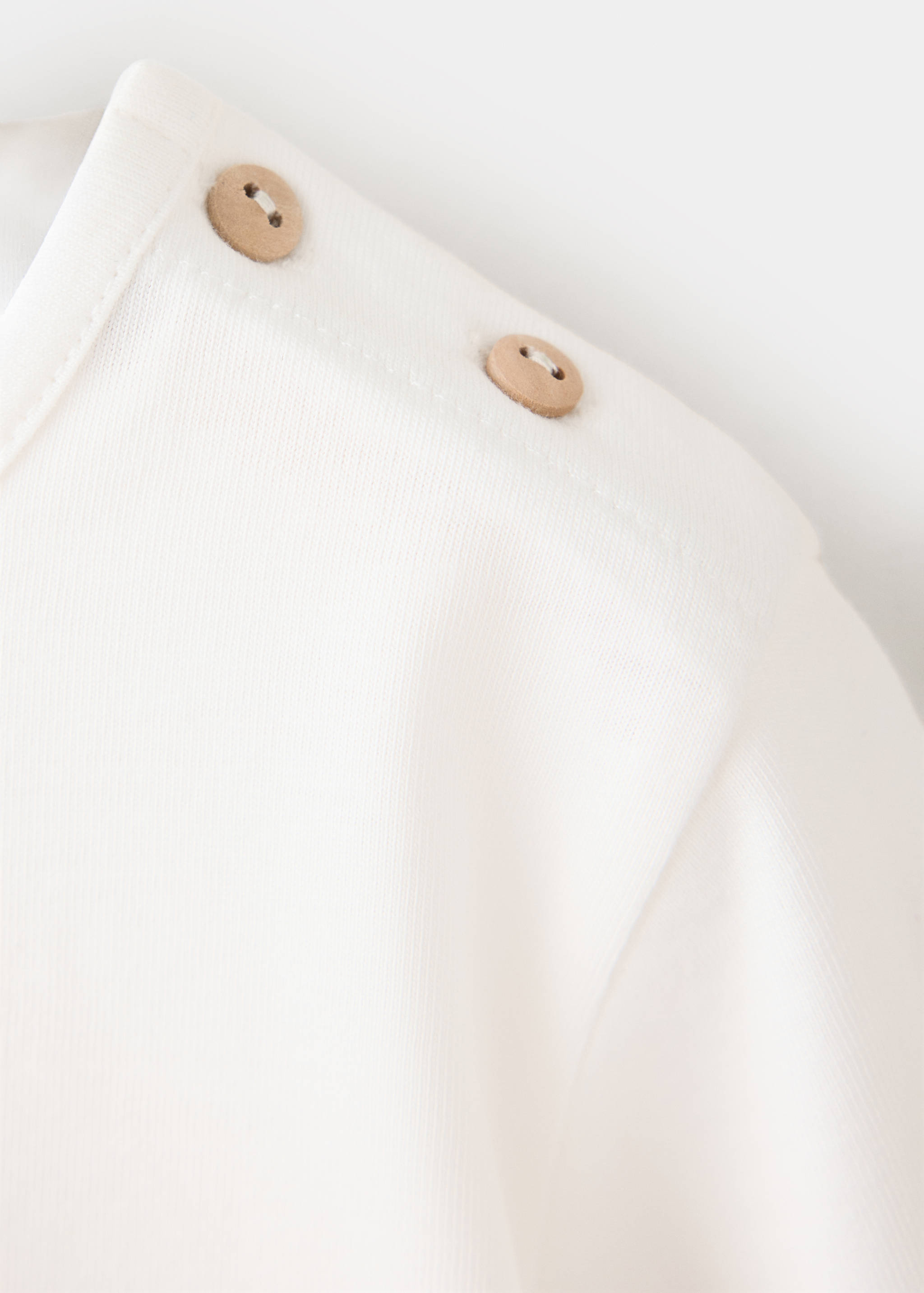 Off-white kids' t-shirt fabric detail with shoulder buttons.