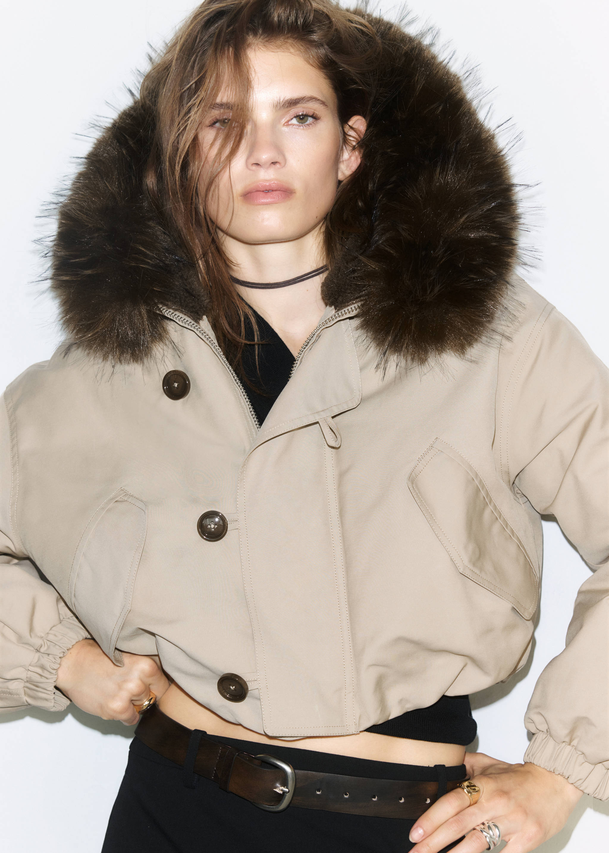 Beige cropped jacket with a brown faux-fur hood and large buttons.