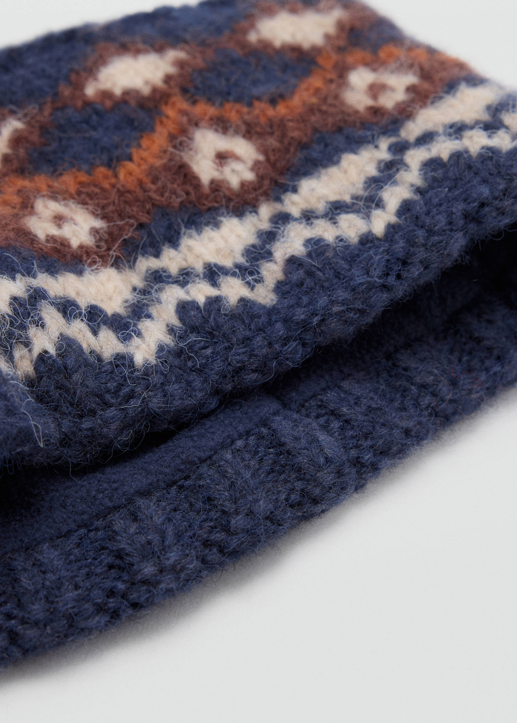 Navy blue, cream and brown knit scarf with a Fair Isle pattern.