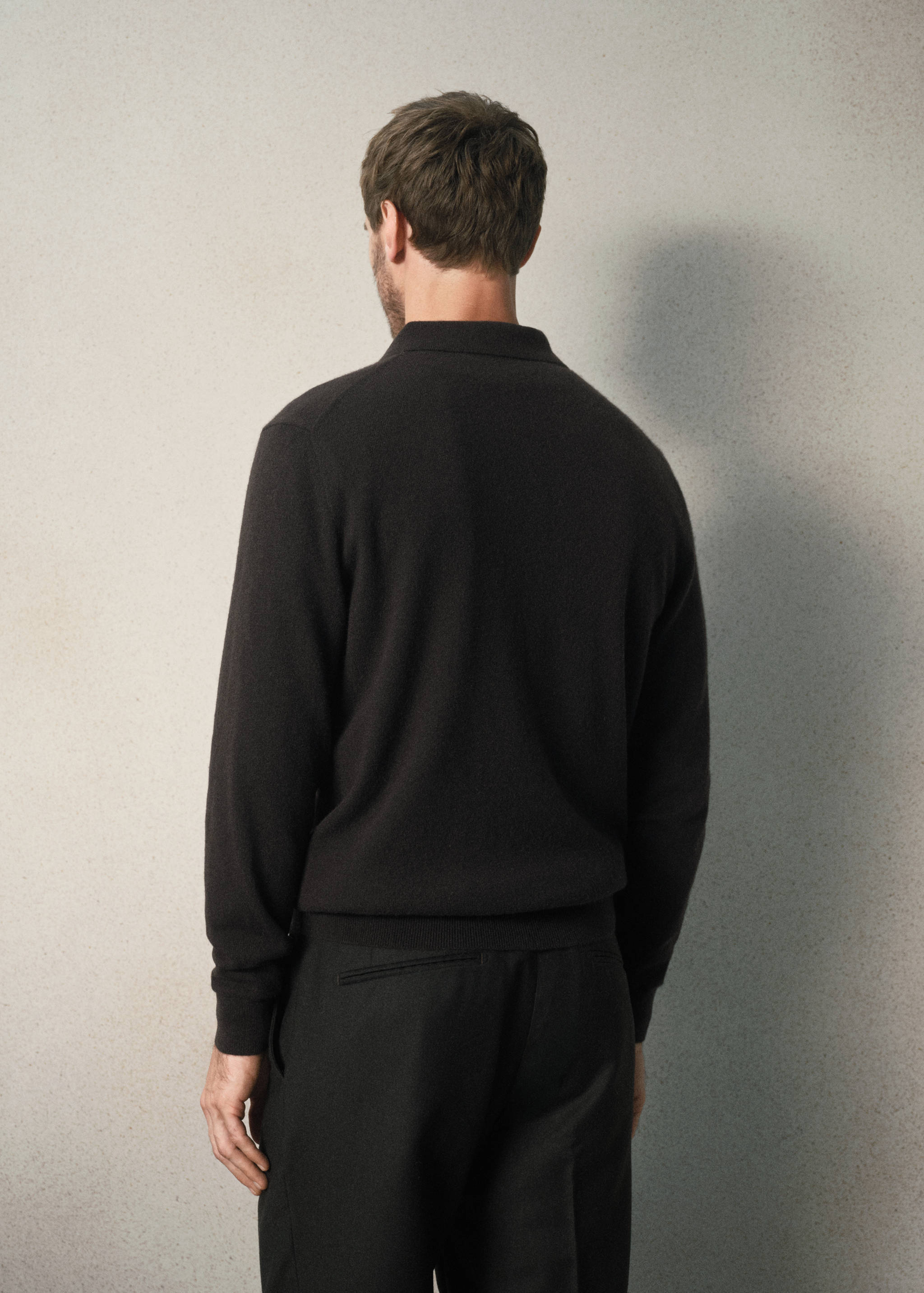 Dark brown knitted polo shirt, back view.