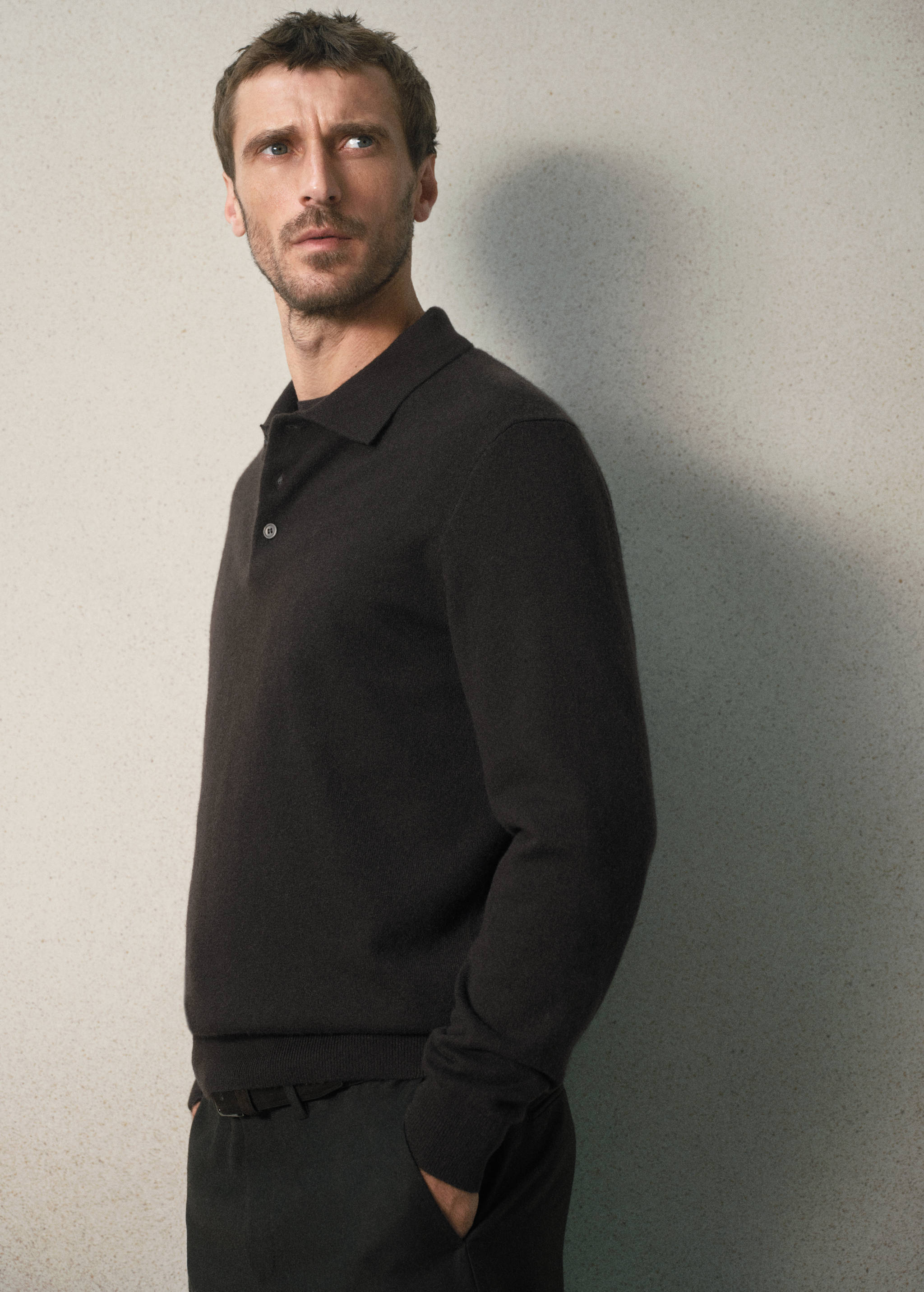 Dark brown long-sleeved polo shirt with a classic collar and button placket.