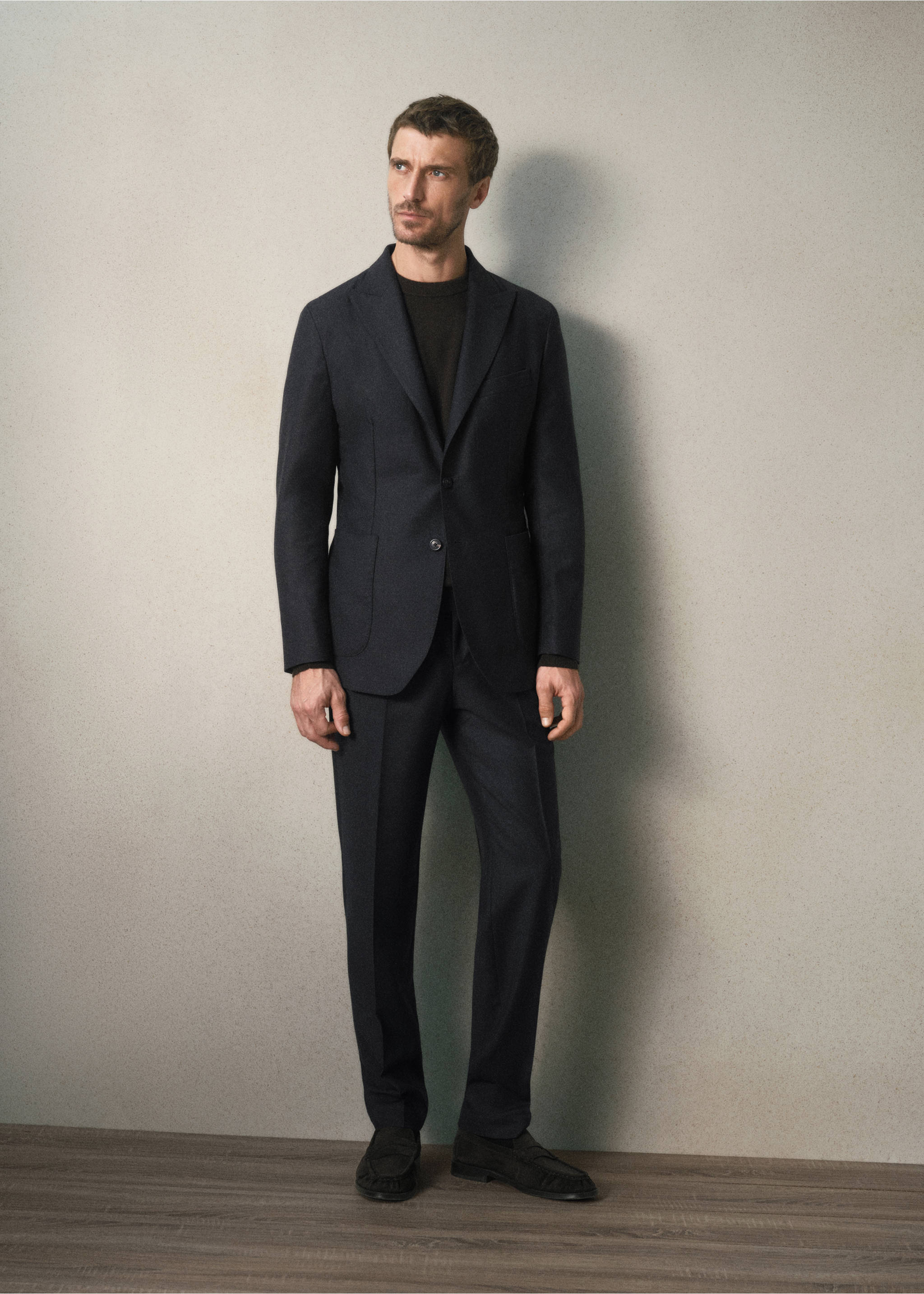 Dark navy blue trousers styled with a matching suit jacket and dark knit top., Charcoal. Ref: 37088283-00.