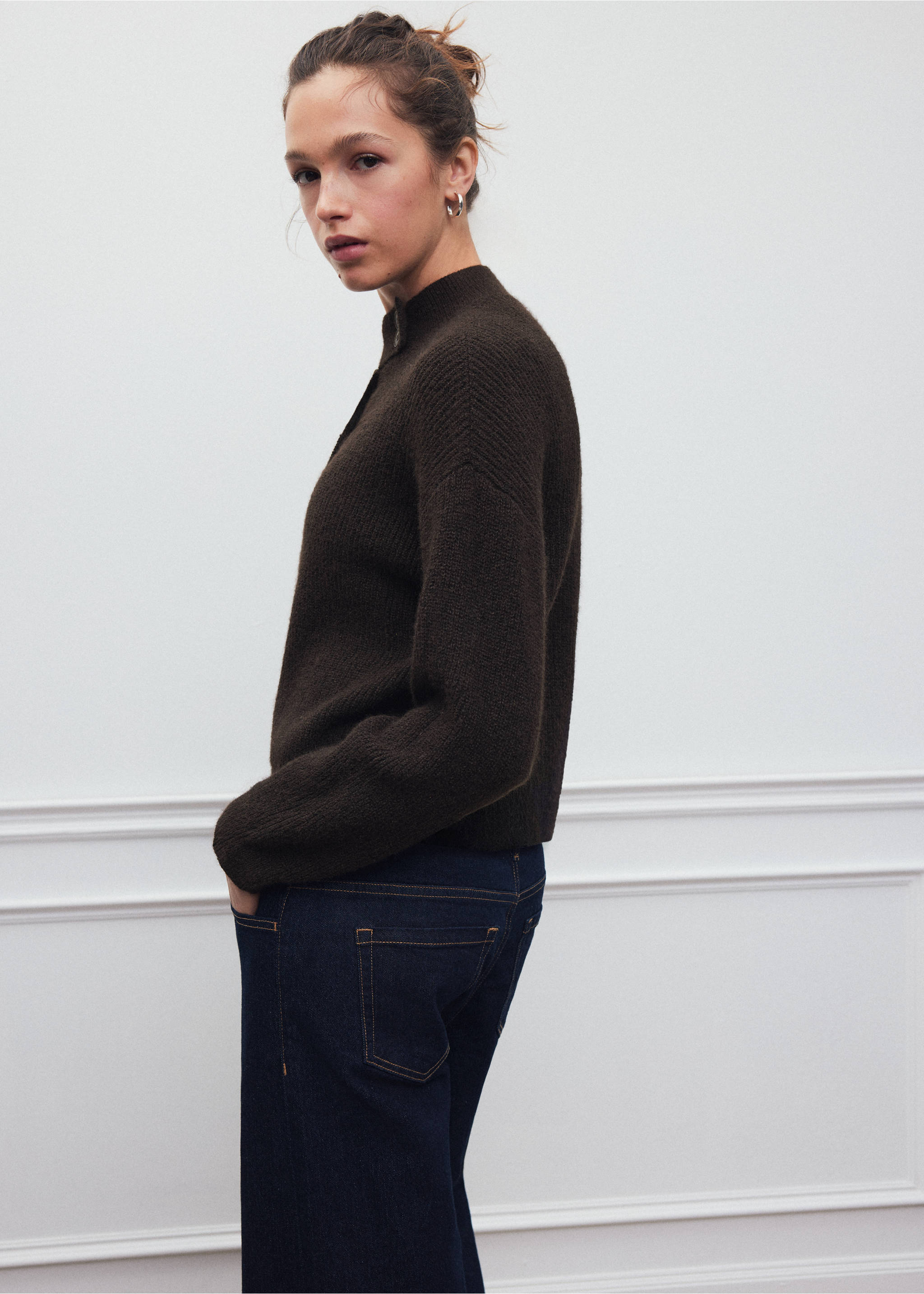 Dark brown high-neck knitted cardigan worn with blue denim trousers., Brown. Ref: 37088285-00.