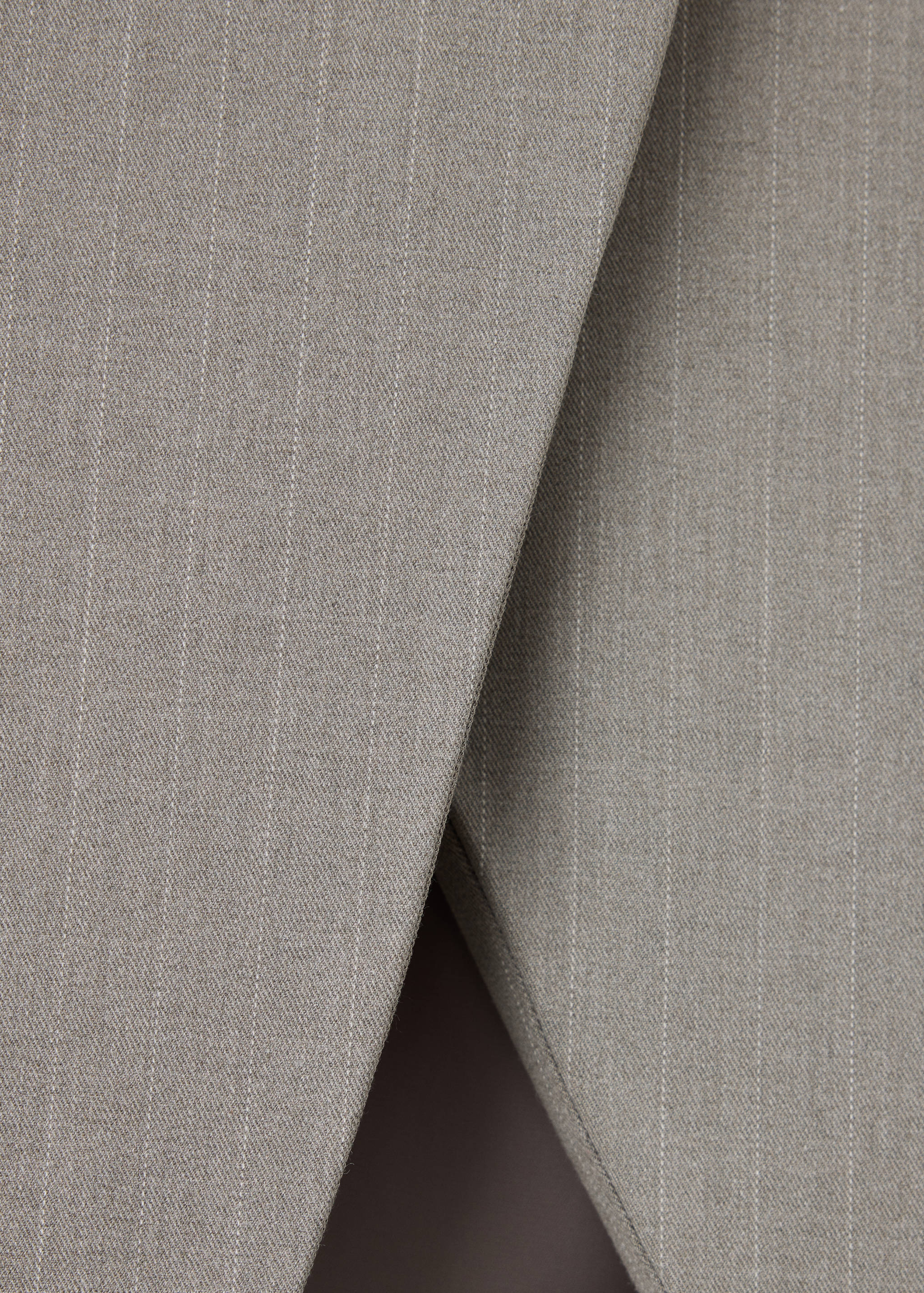 Grey pinstripe skirt fabric detail.