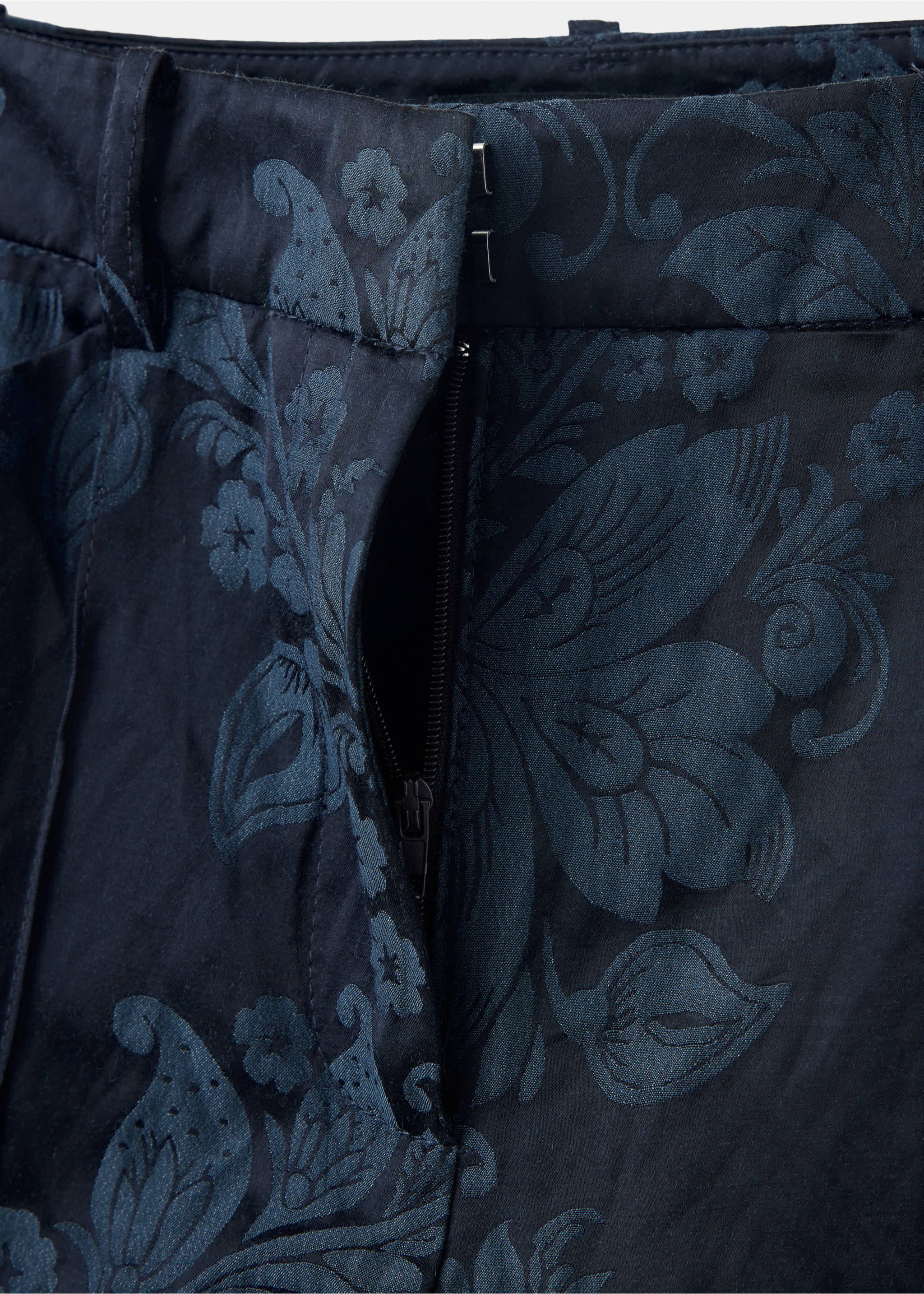 Close-up of navy blue trousers with a tonal floral jacquard pattern., Blue. Ref: 37089114-00.