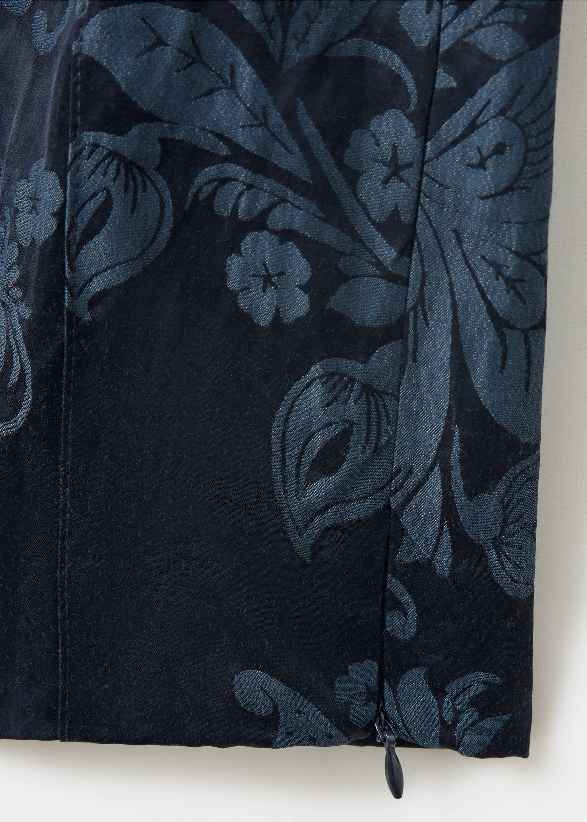Close-up of navy blue trousers featuring a tonal floral fabric detail and hem zip., Blue. Ref: 37089114-00.