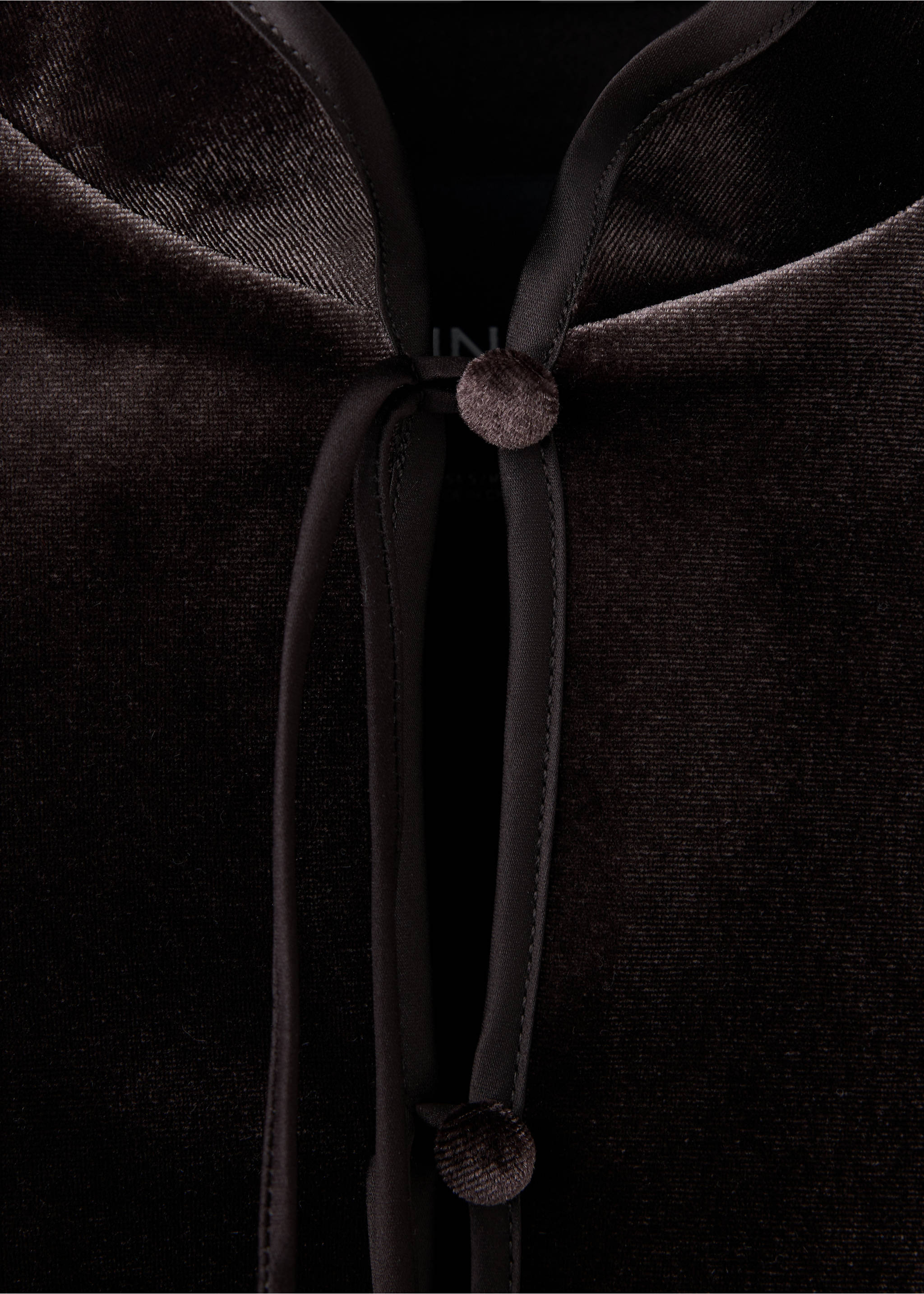 Close-up of a dark brown velvet jacket with satin piping and button closure., Chocolate. Ref: 37089117-00.