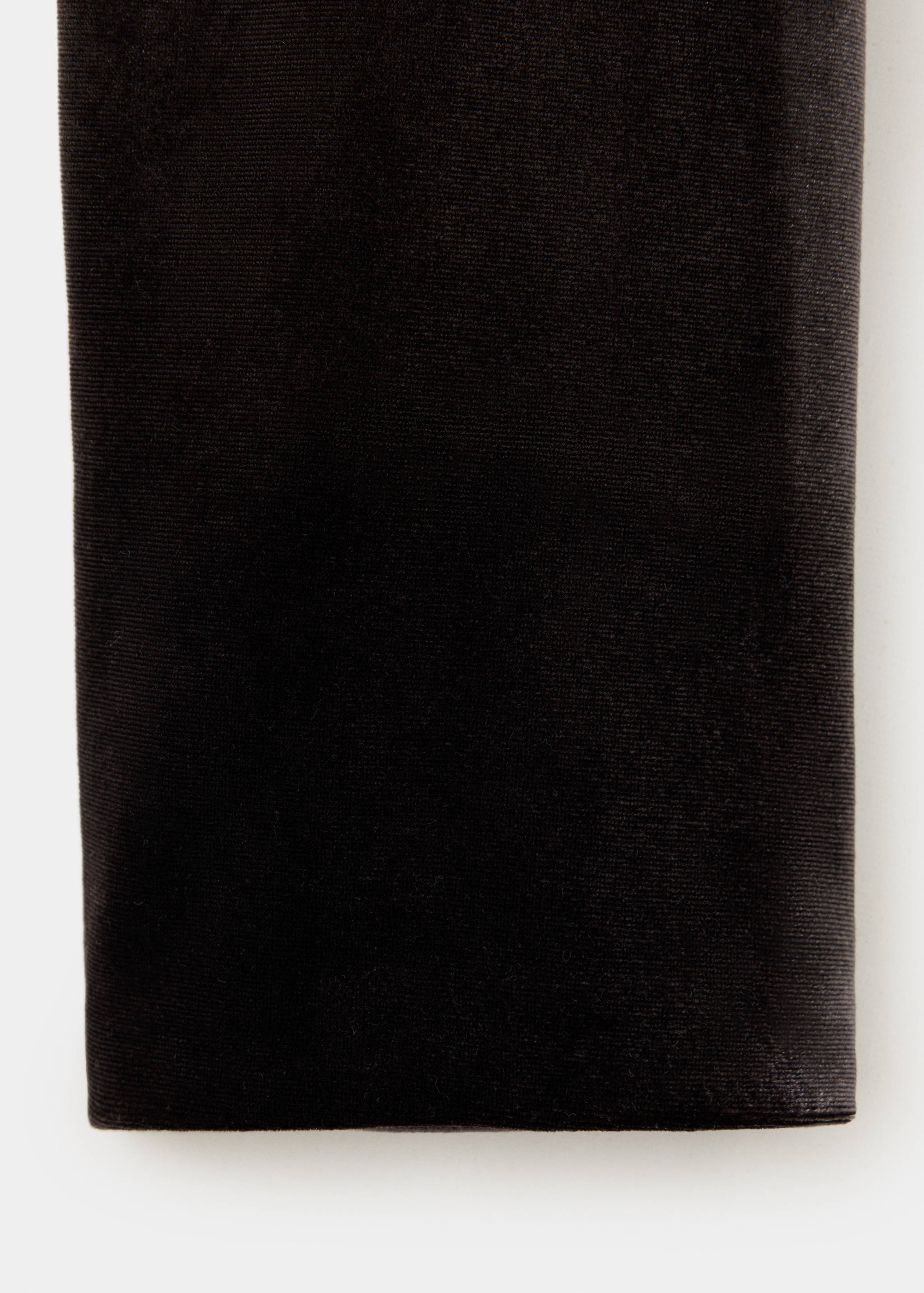 Close-up of the black velvet fabric texture on a jacket.