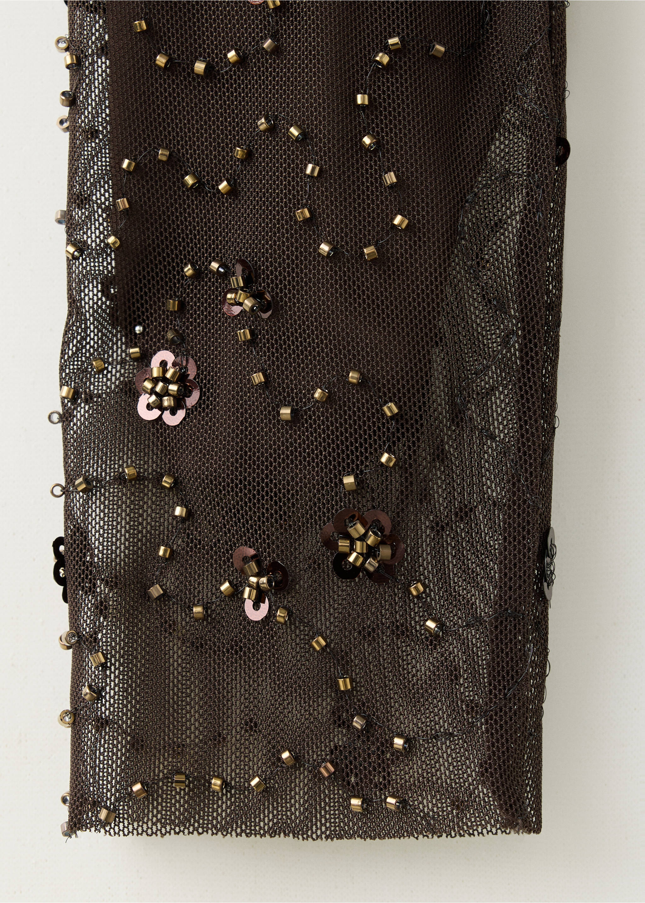 Close-up of a dark brown sheer mesh blouse with metallic beads and sequins., Brown. Ref: 37089124-00.