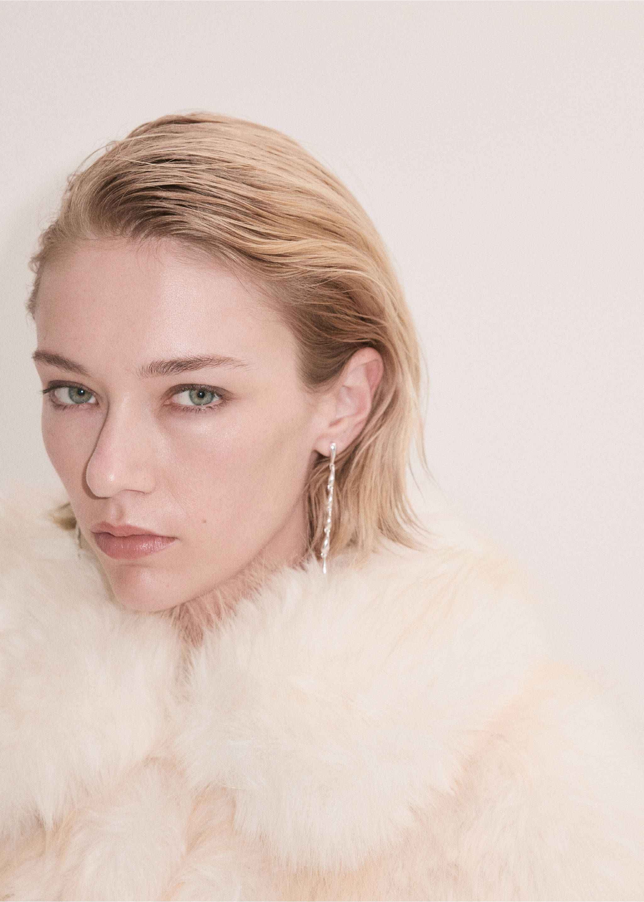 Close-up of off-white faux-fur jacket collar on model with earrings., White. Ref: 37089126-00.