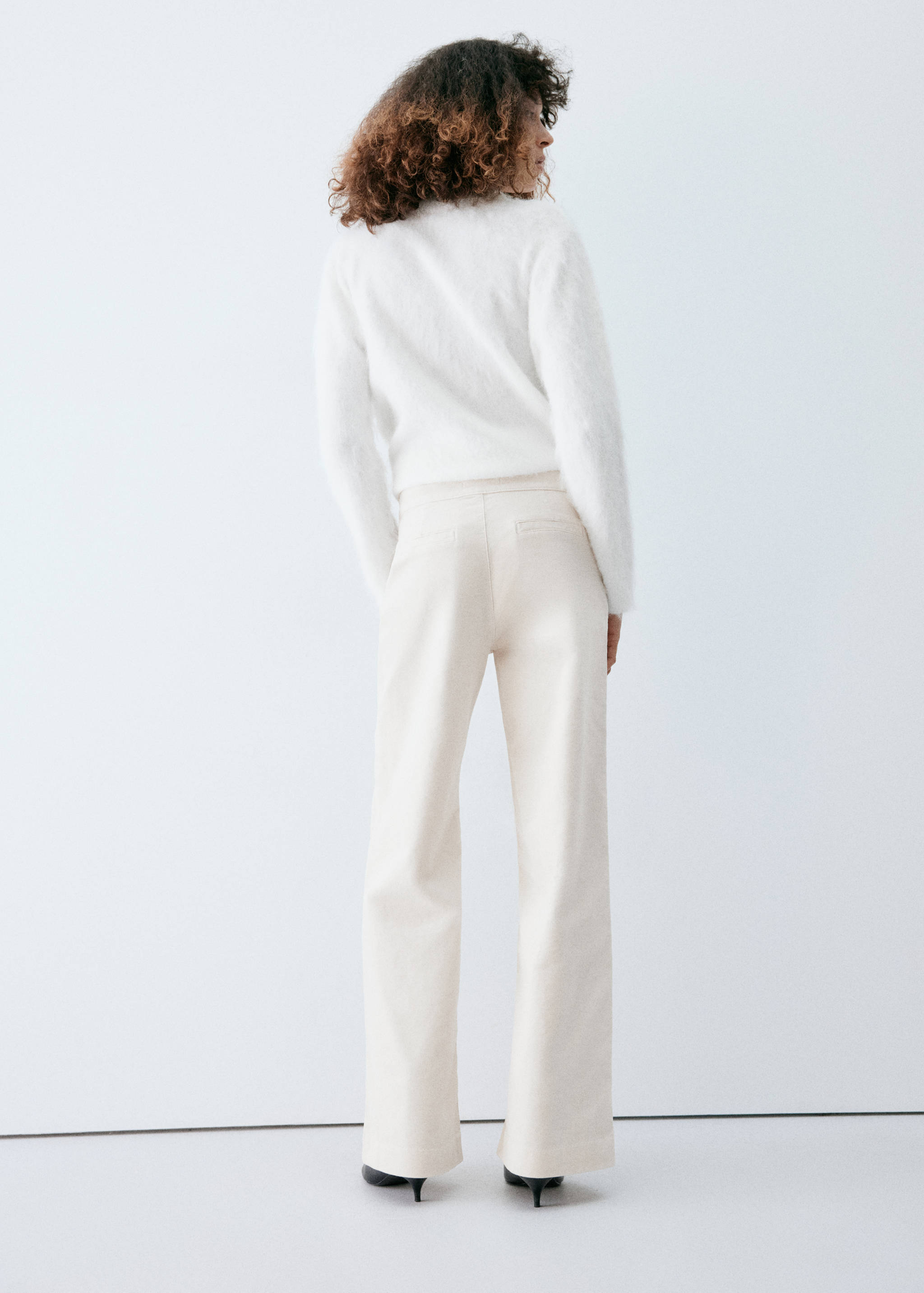 Back view of cream denim trousers in a straight-leg fit.