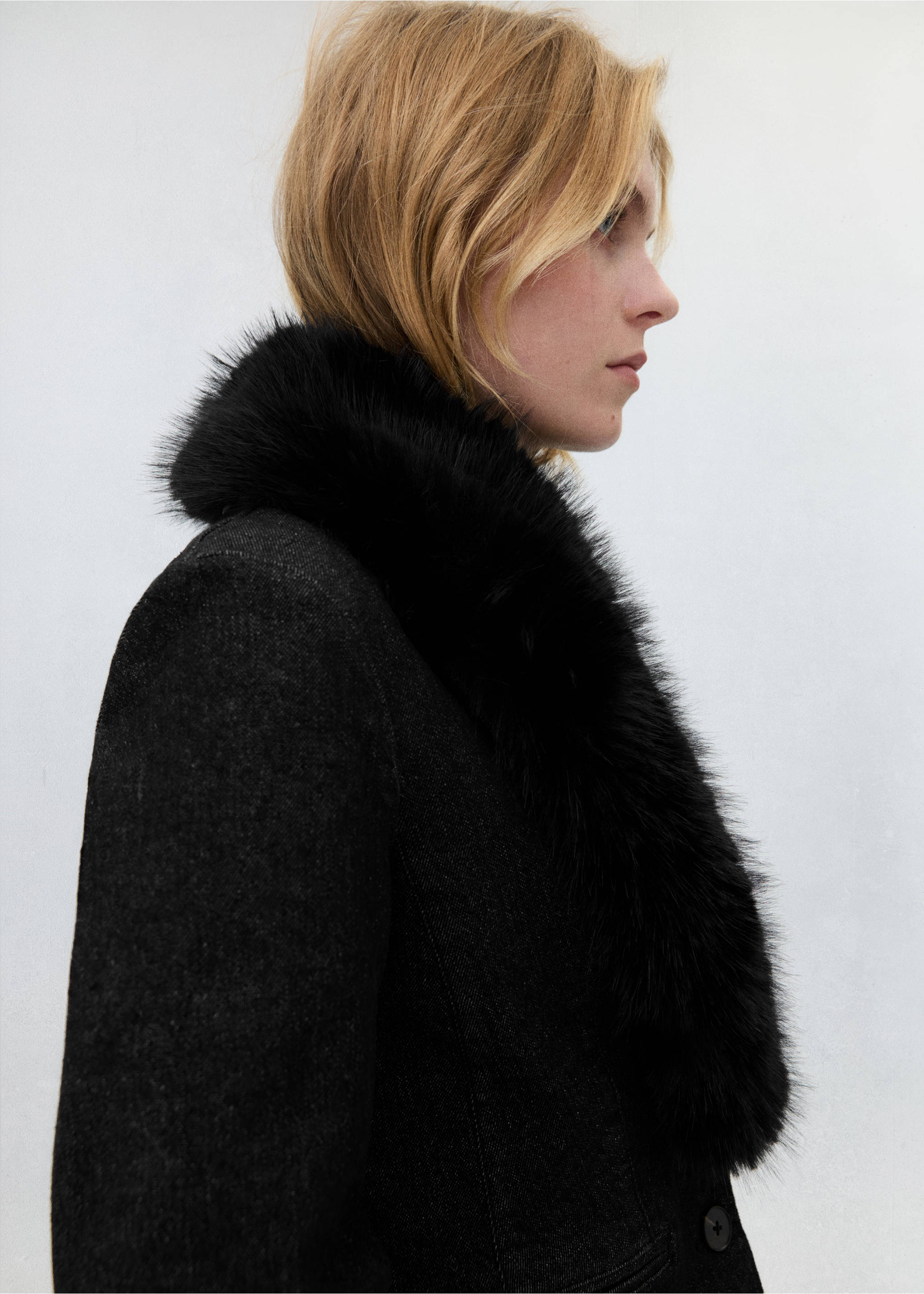 Close-up of a dark grey blazer with a fluffy black faux-fur collar., Open Blue. Ref: 37089134-01.