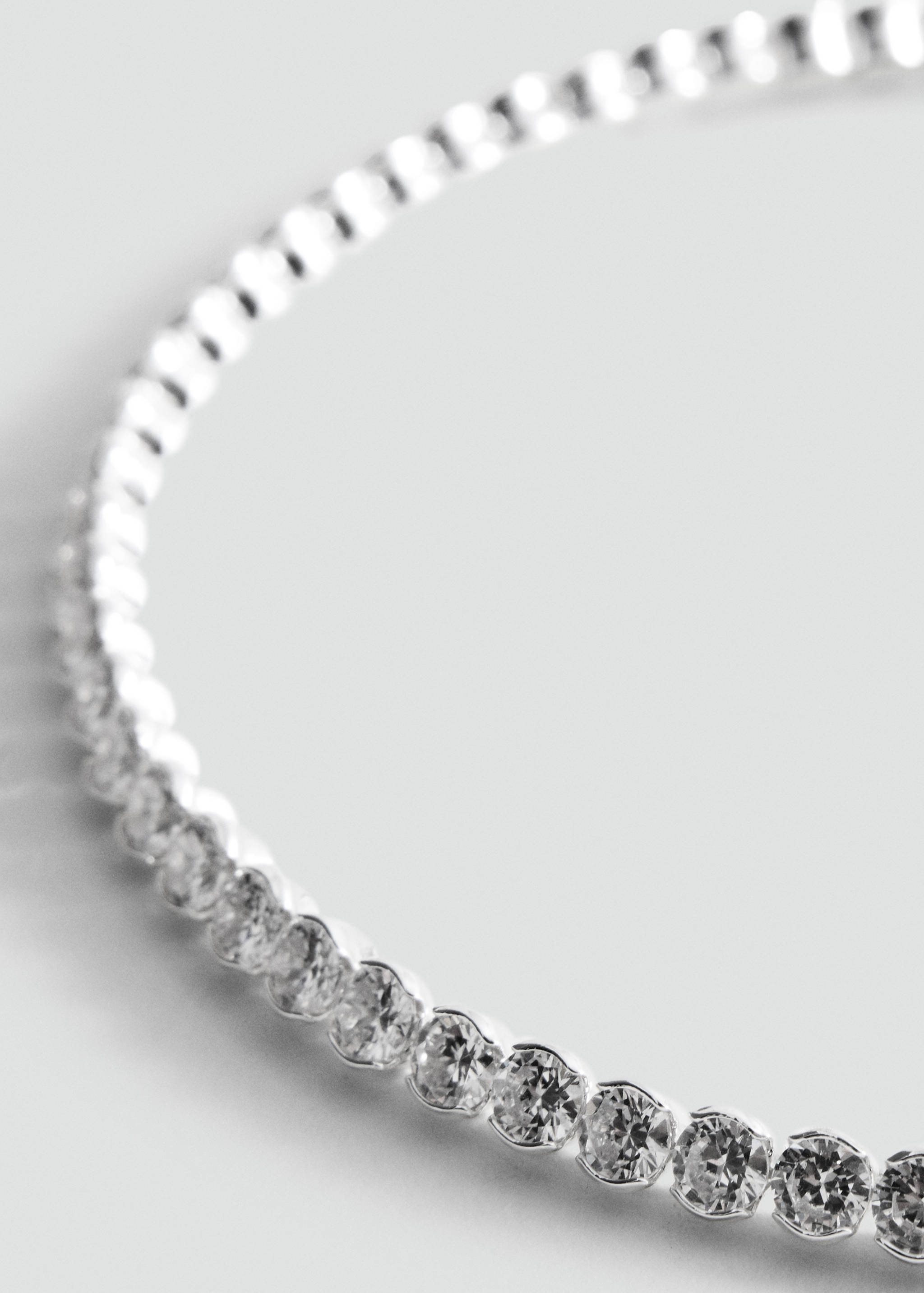 Silver-toned crystal collar necklace in a three-quarter view.