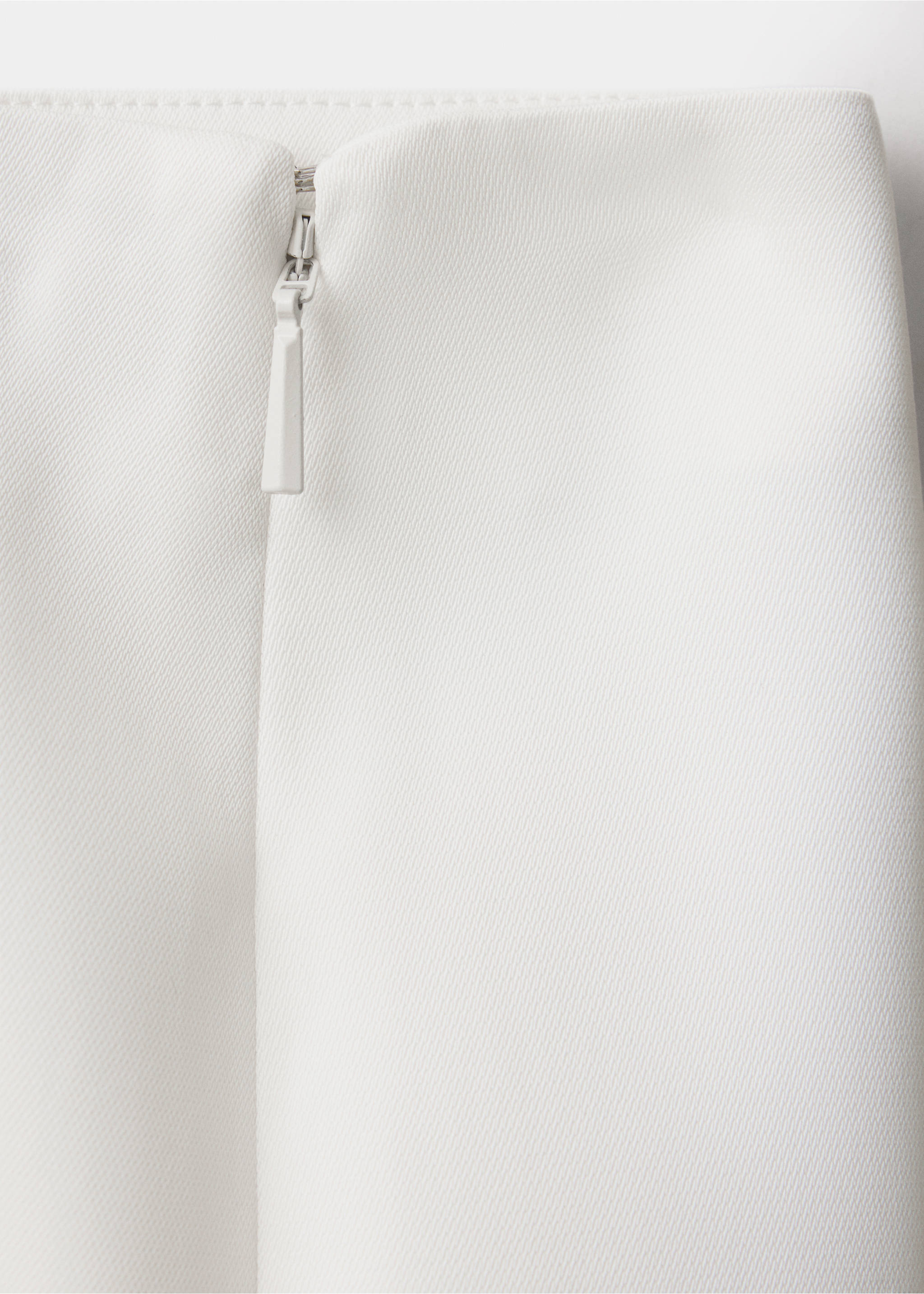 Close-up of white trousers showing textured fabric and side zip., Ecru. Ref: 37089143-00.