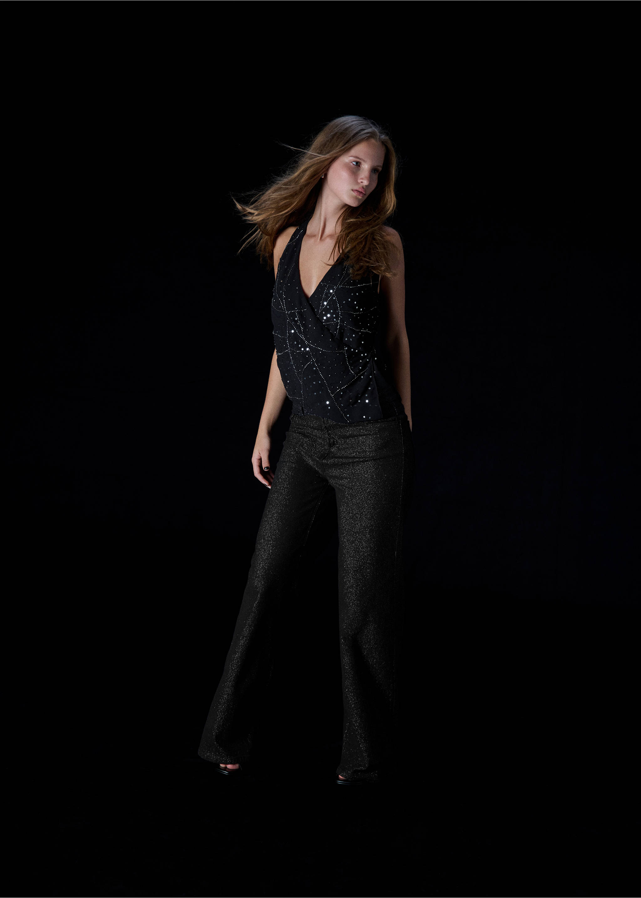 Black halter-neck top with rhinestone embellishments, worn with dark trousers., Black. Ref: 37089212-00.