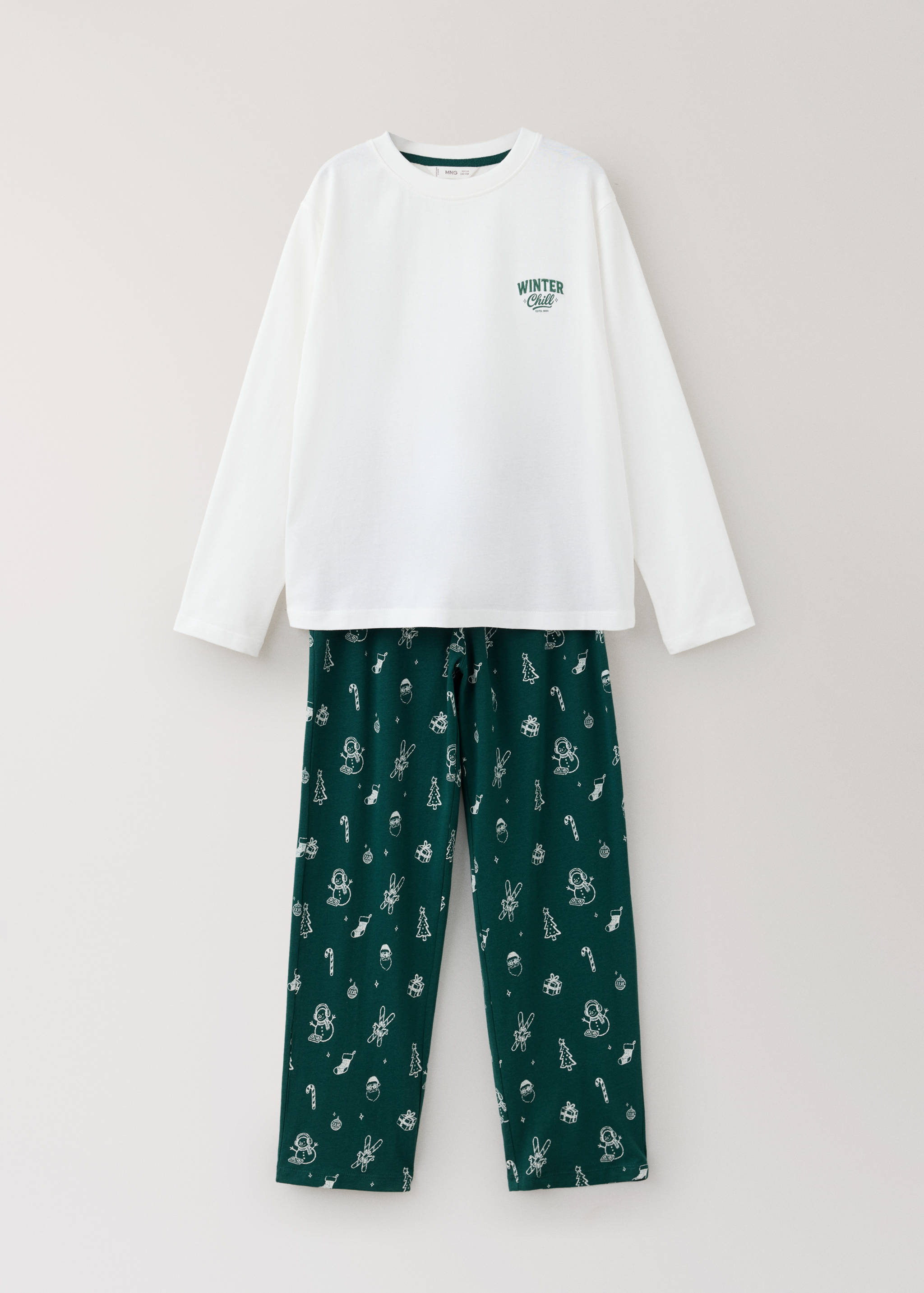 White long-sleeved pyjama top and green Christmas-print trousers.