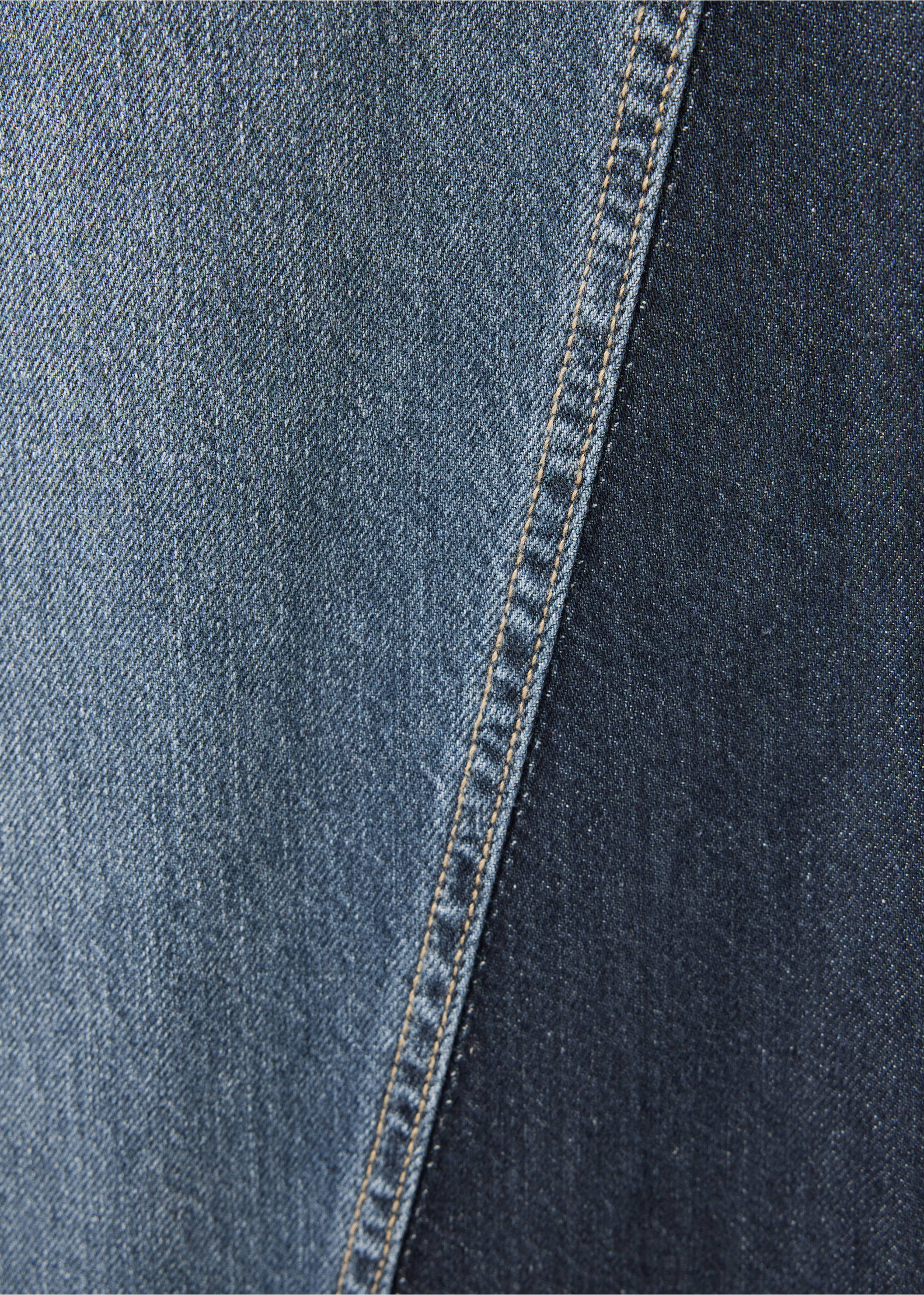 Close-up of two-tone denim fabric with a seam and contrast topstitching., Dark Blue. Ref: 37089214-00.
