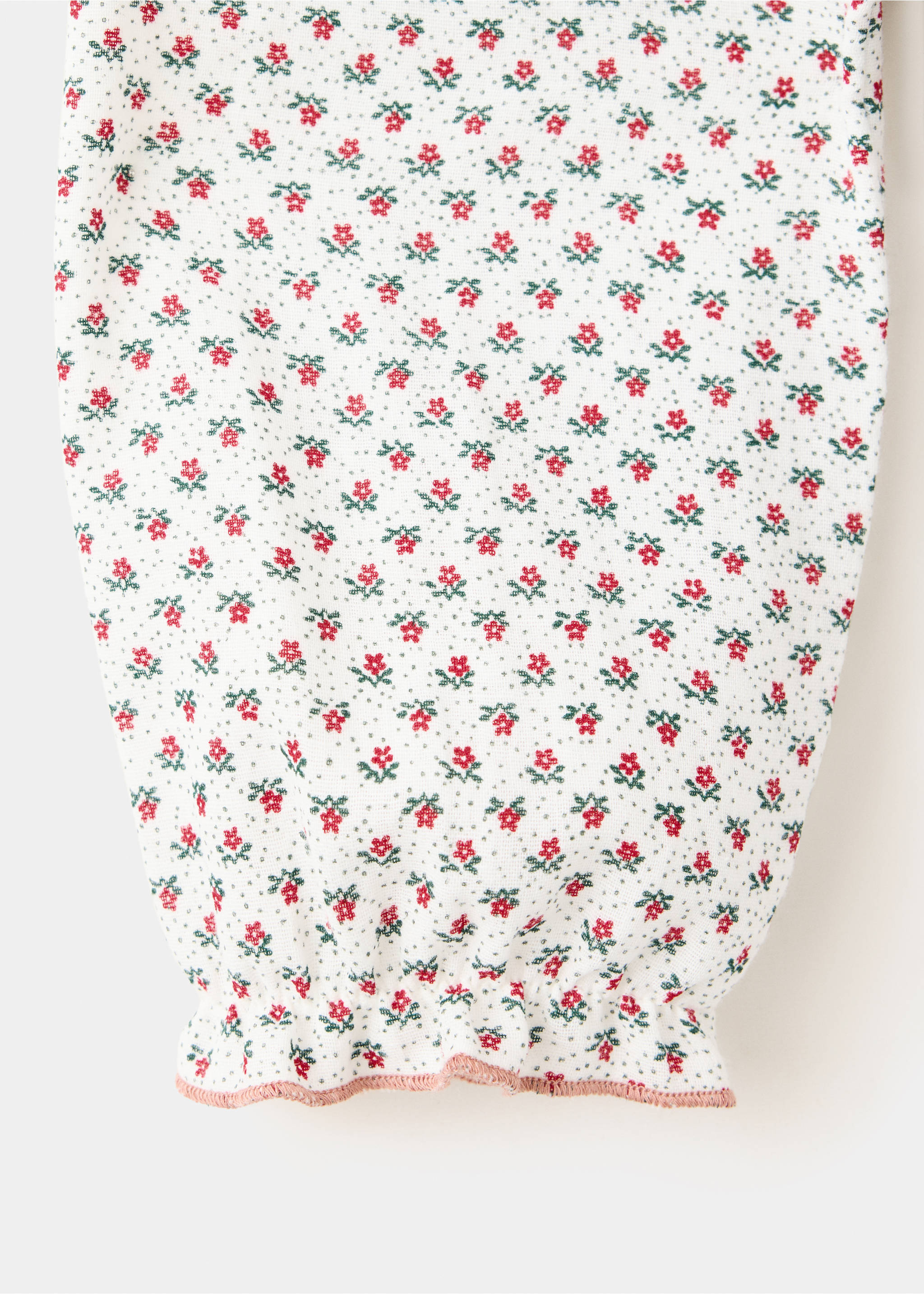Close-up of a white floral blouse sleeve with a gathered cuff and pink trim., Off White. Ref: 37089217-00.
