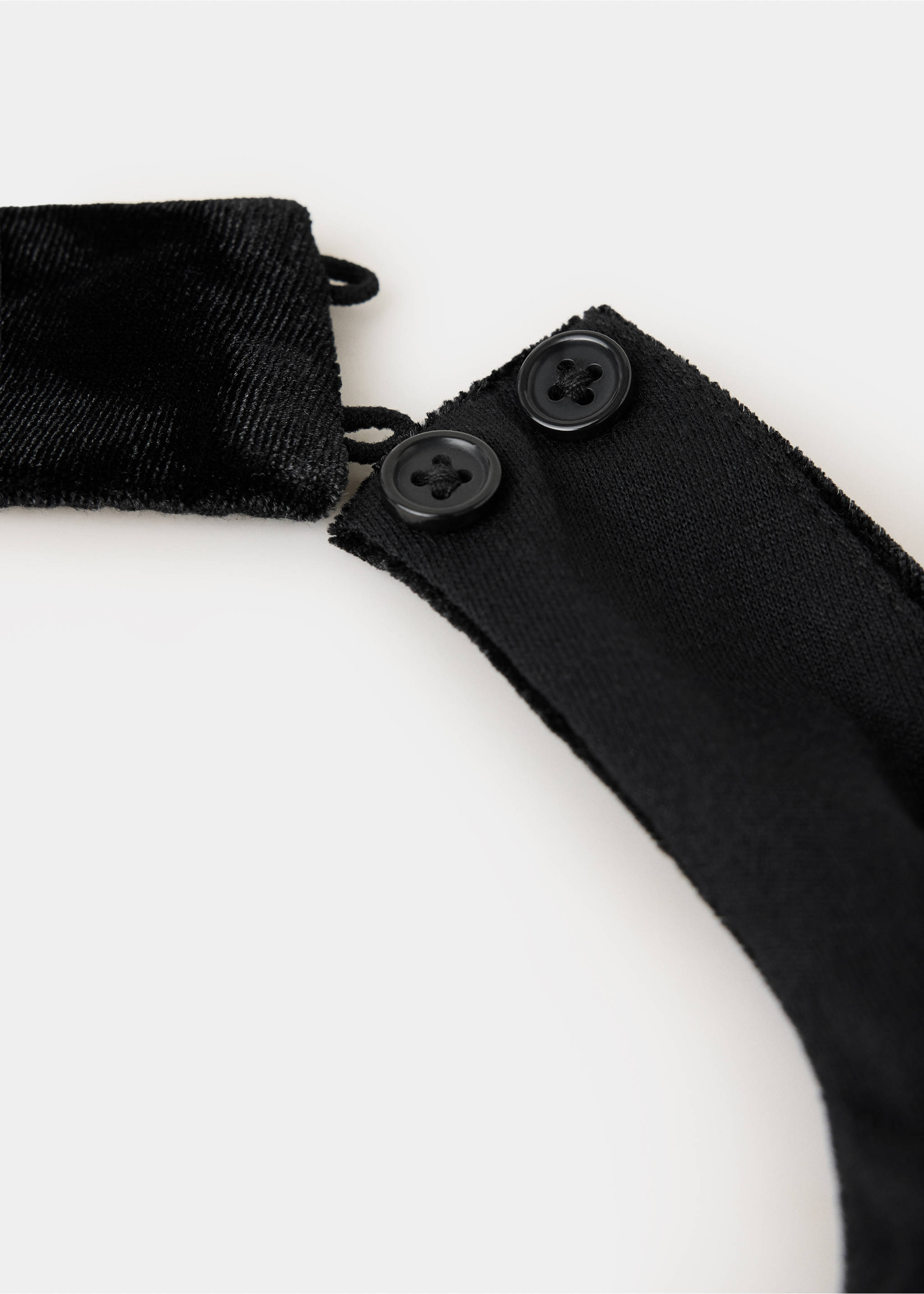 Close-up of a black top showing button closure and fabric detail., Black. Ref: 37089220-00.