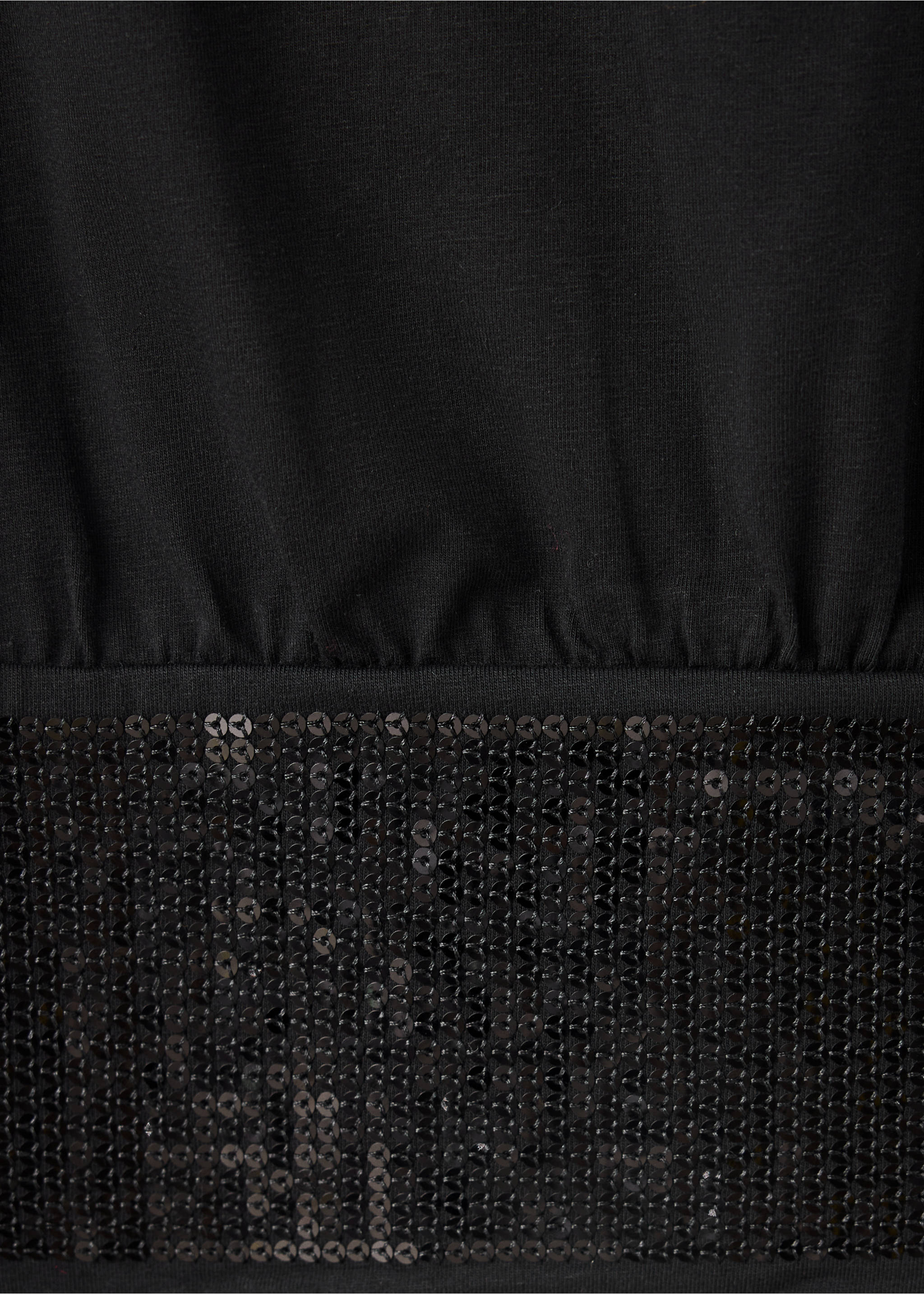 Close-up of a black t-shirt with a sequin hem., Black. Ref: 37089227-00.