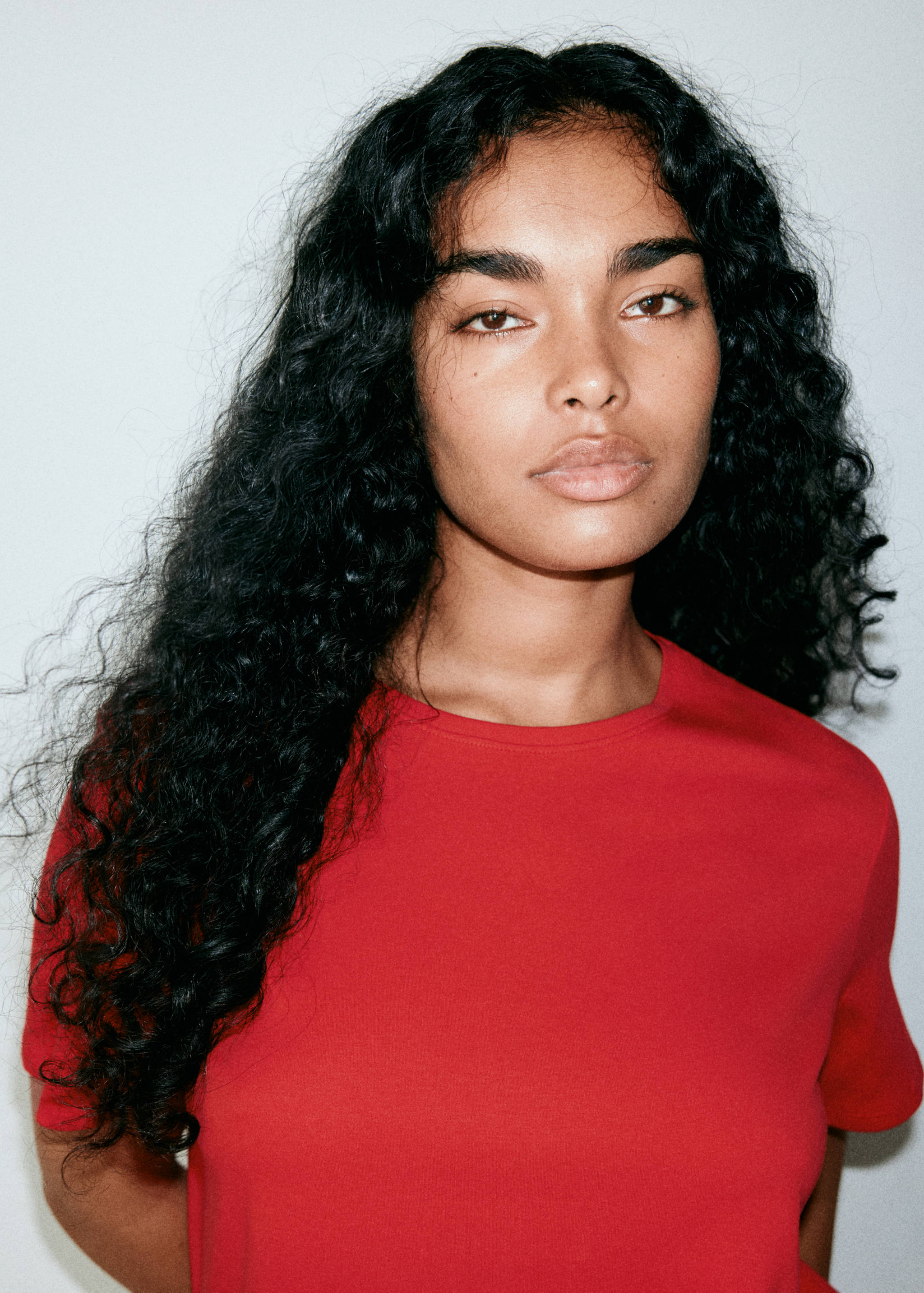 Red short-sleeved t-shirt with a round neck in a close-up view.