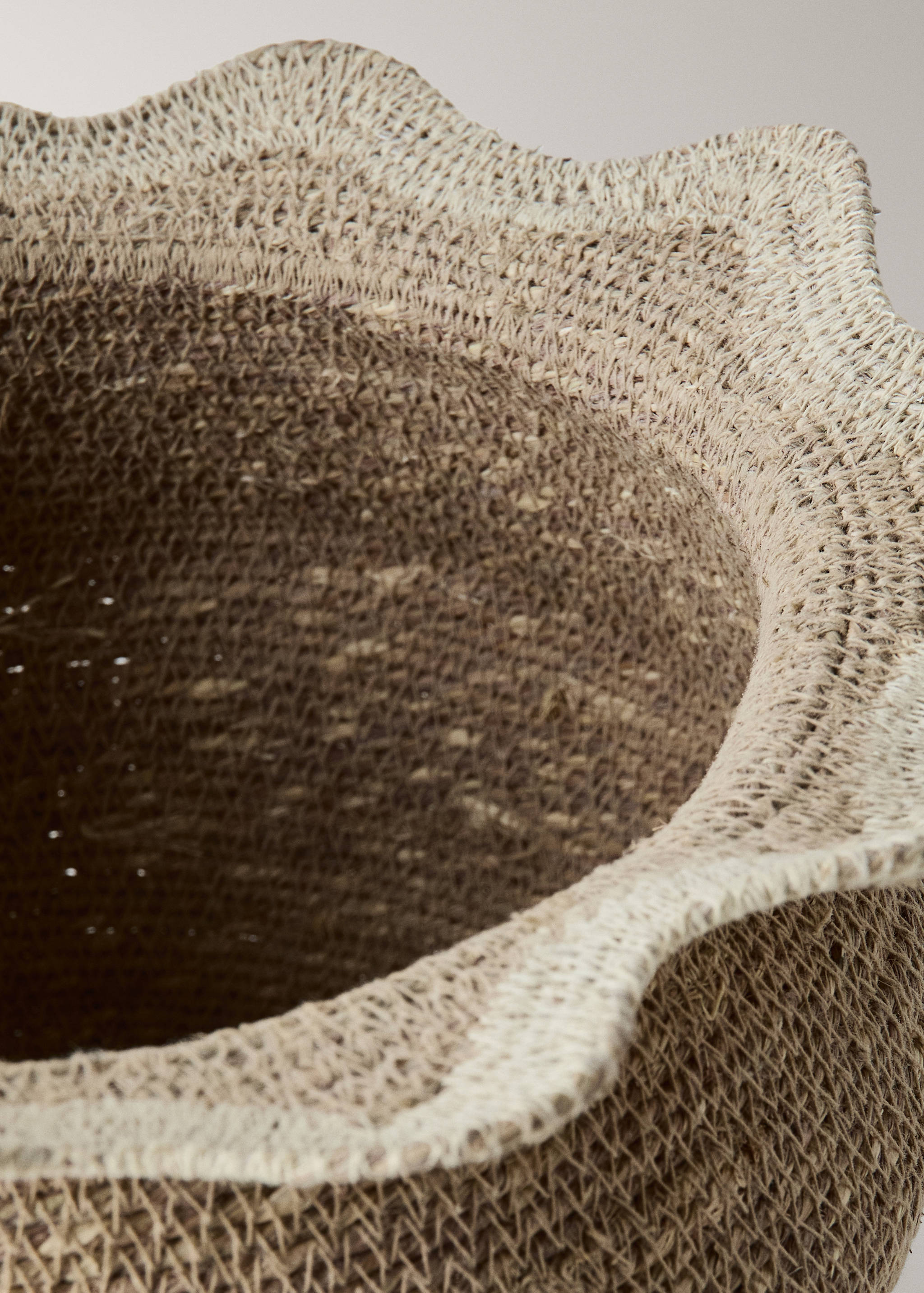 Close-up of a woven basket featuring a scalloped rim.