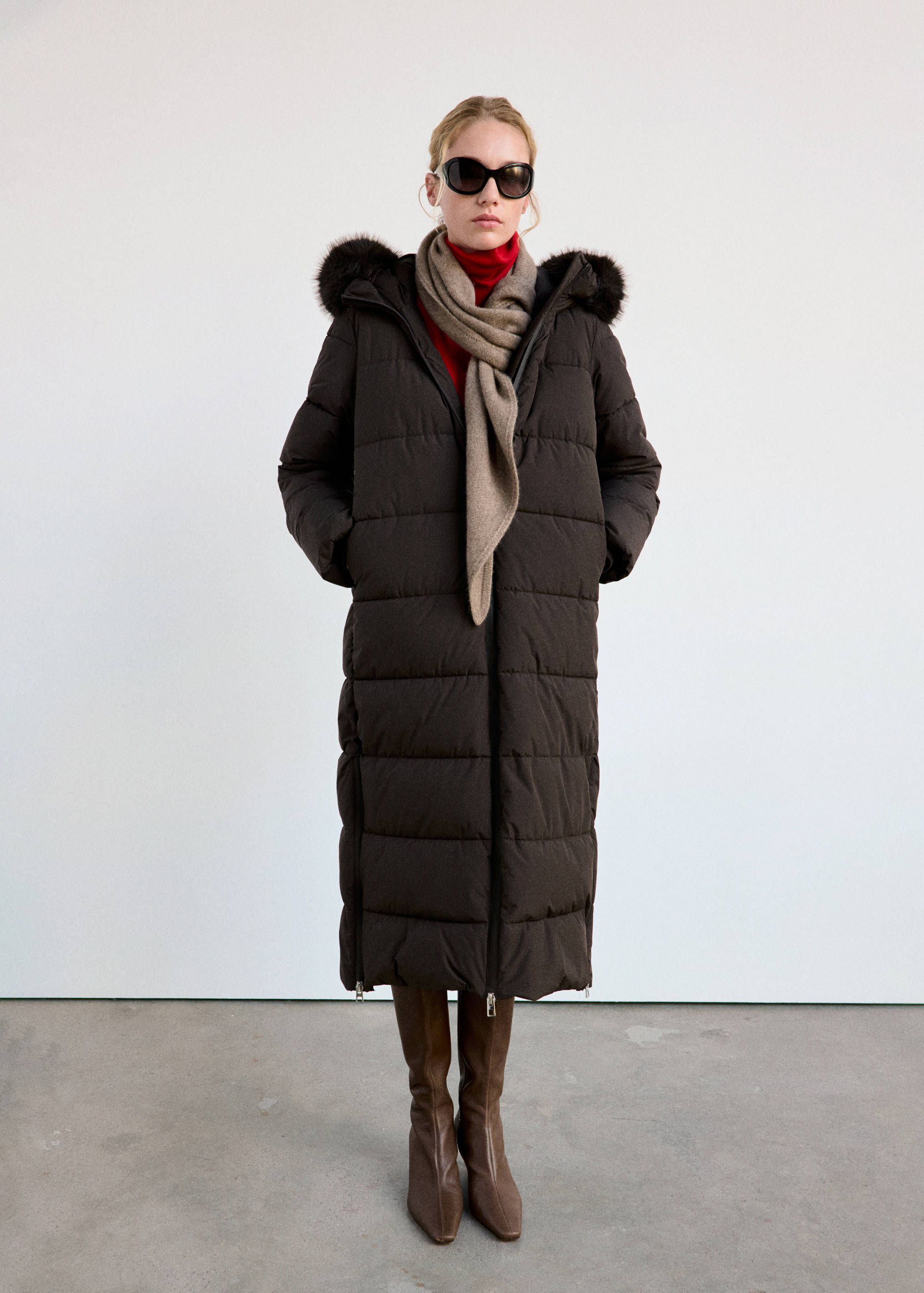 Dark brown long quilted anorak with a faux-fur trimmed hood.