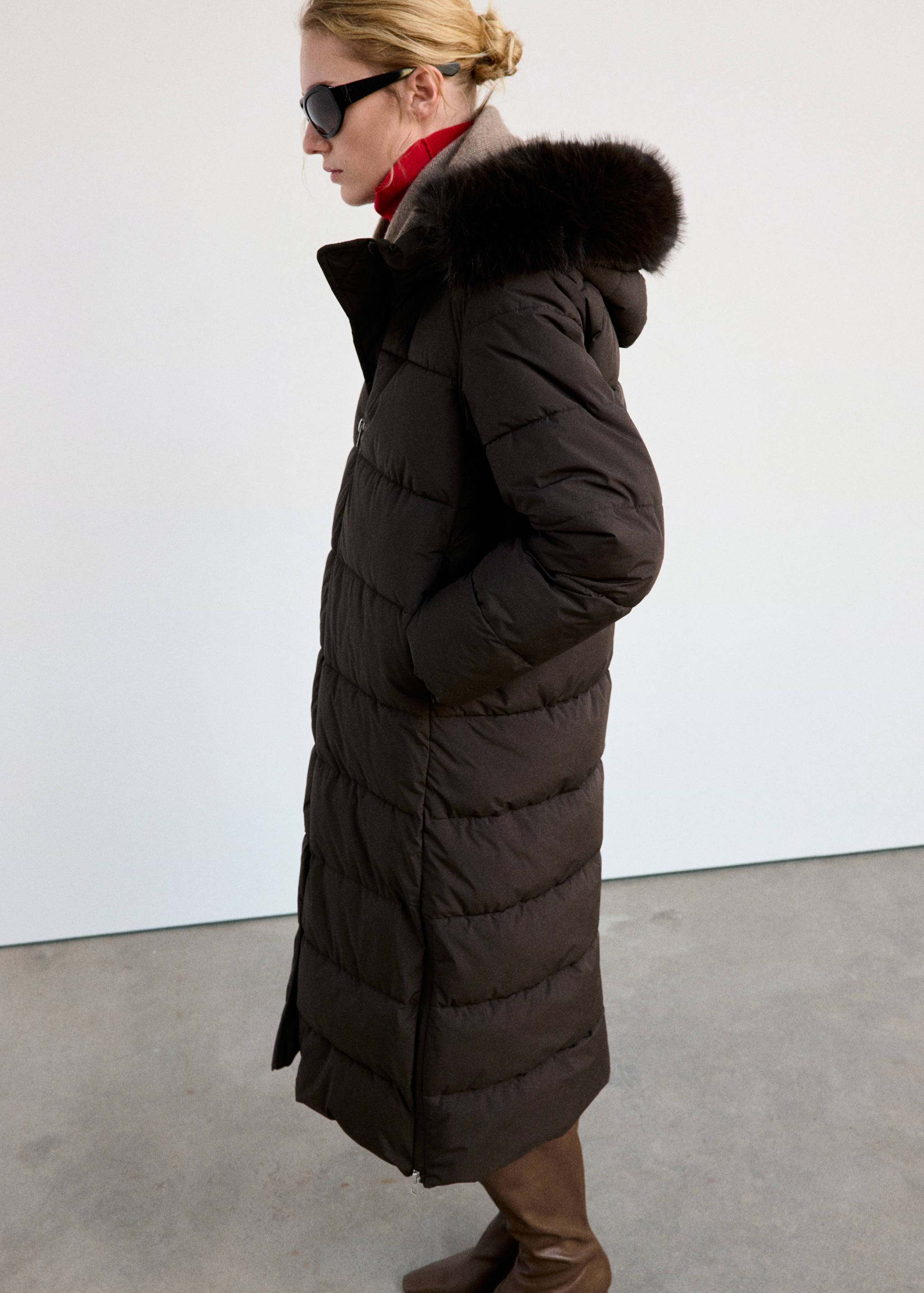 Dark brown quilted long anorak with a faux-fur trimmed hood.