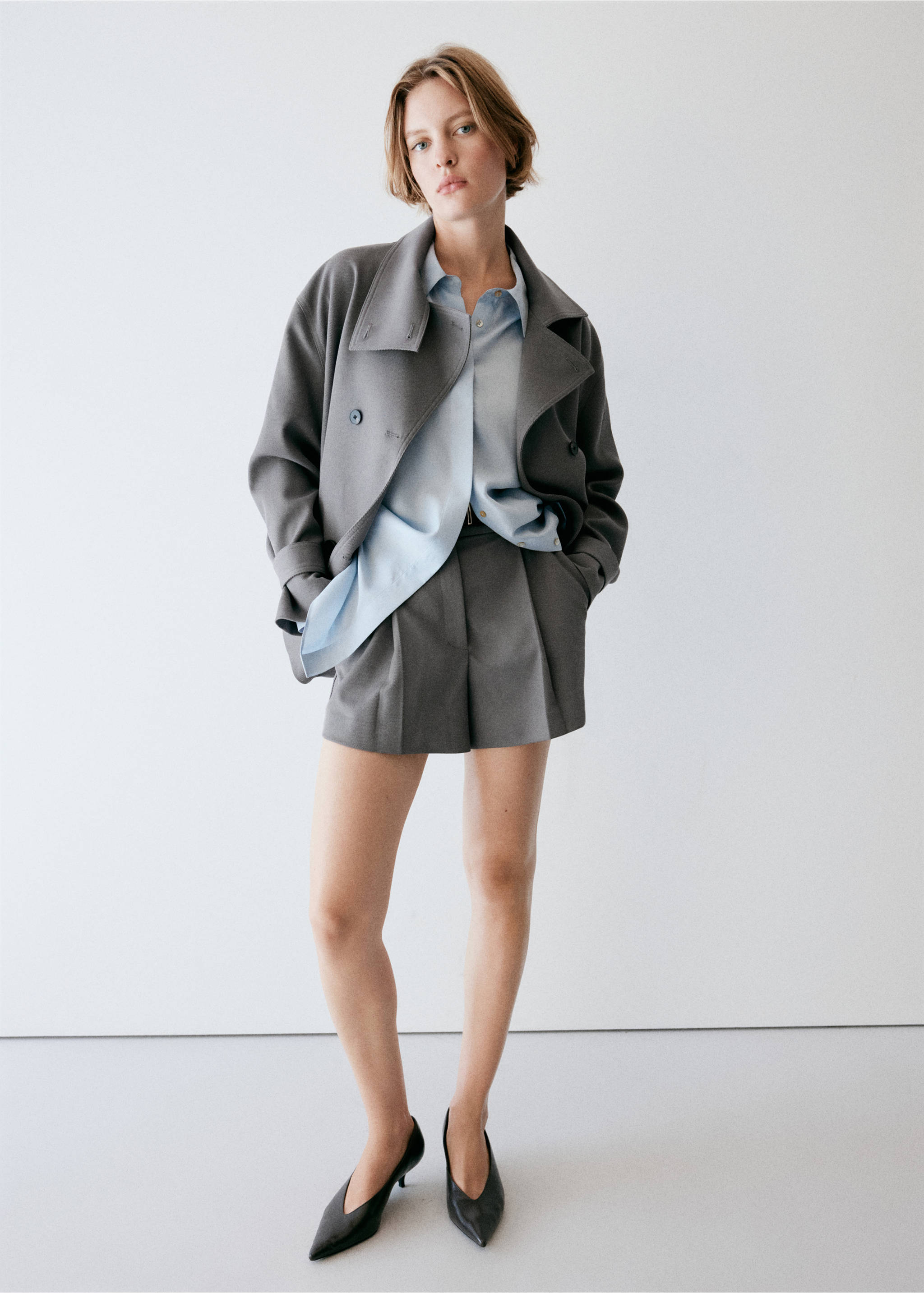 Grey pleated shorts worn with a light blue shirt and grey jacket., Grey. Ref: 37094775-01.