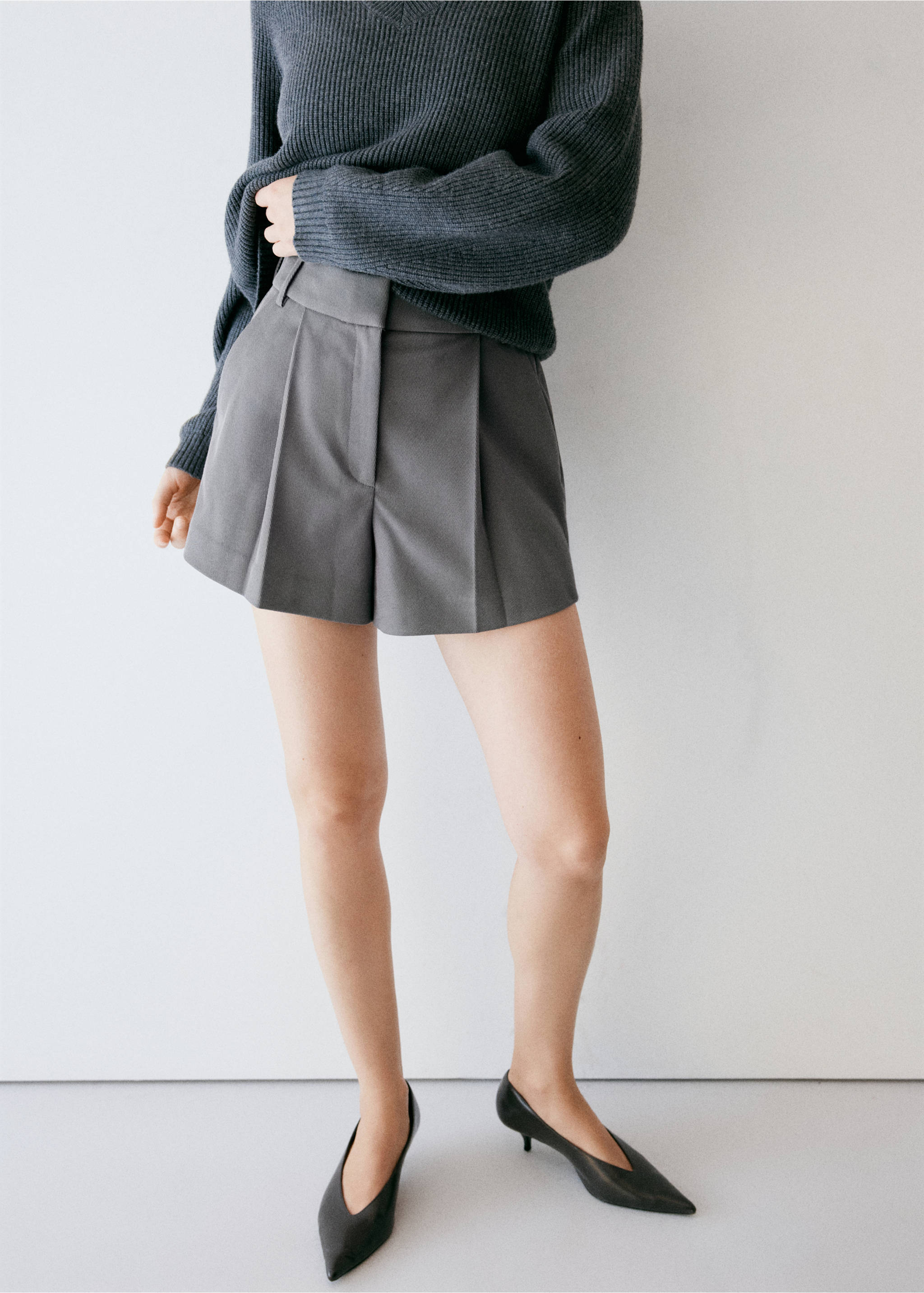 Grey tailored pleated shorts styled with a dark grey sweater., Grey. Ref: 37094775-01.