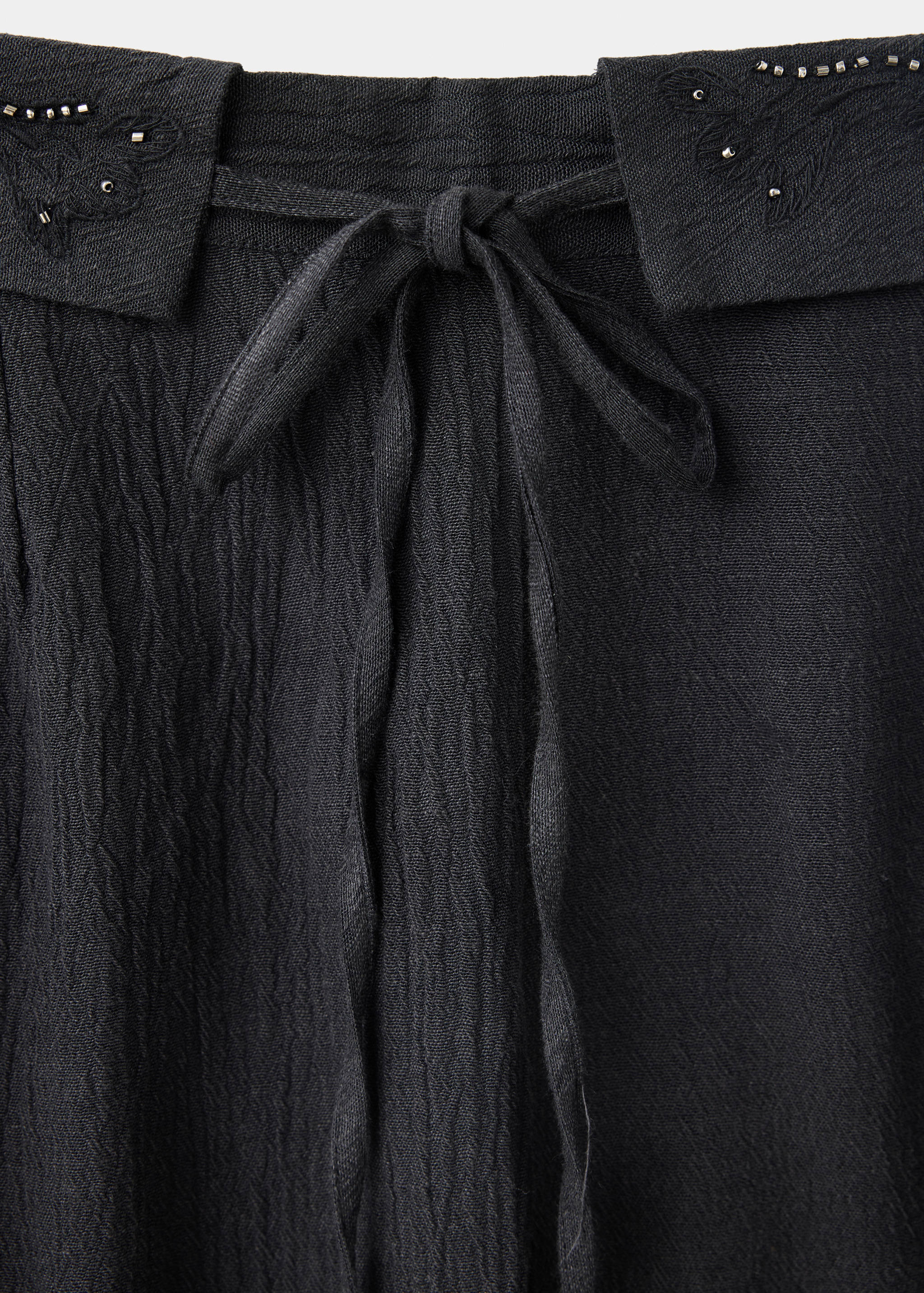 Trousers with embroidered turn-up waistline - Details of the article 0