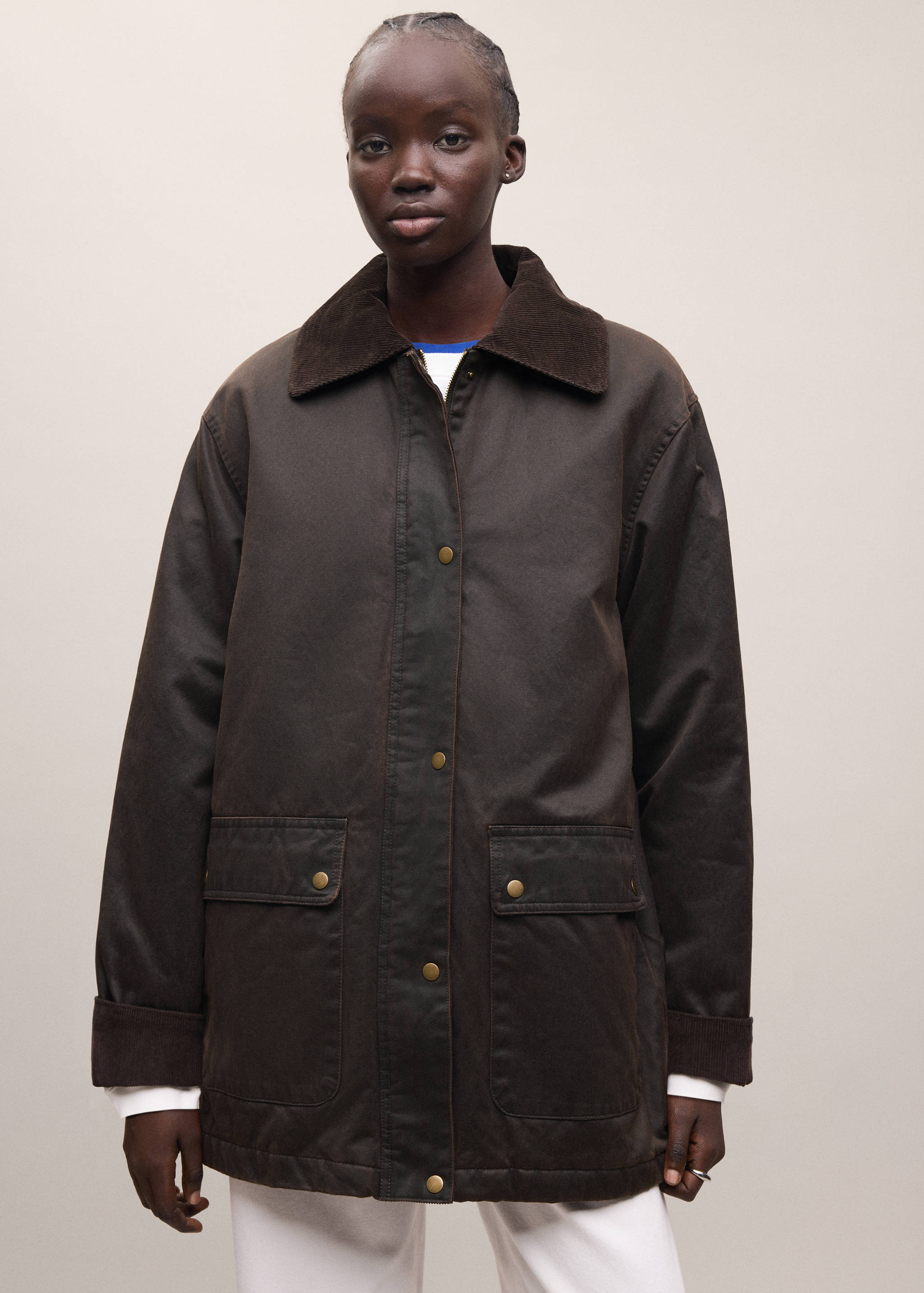 Dark brown parka with a contrasting corduroy collar and front snap buttons.