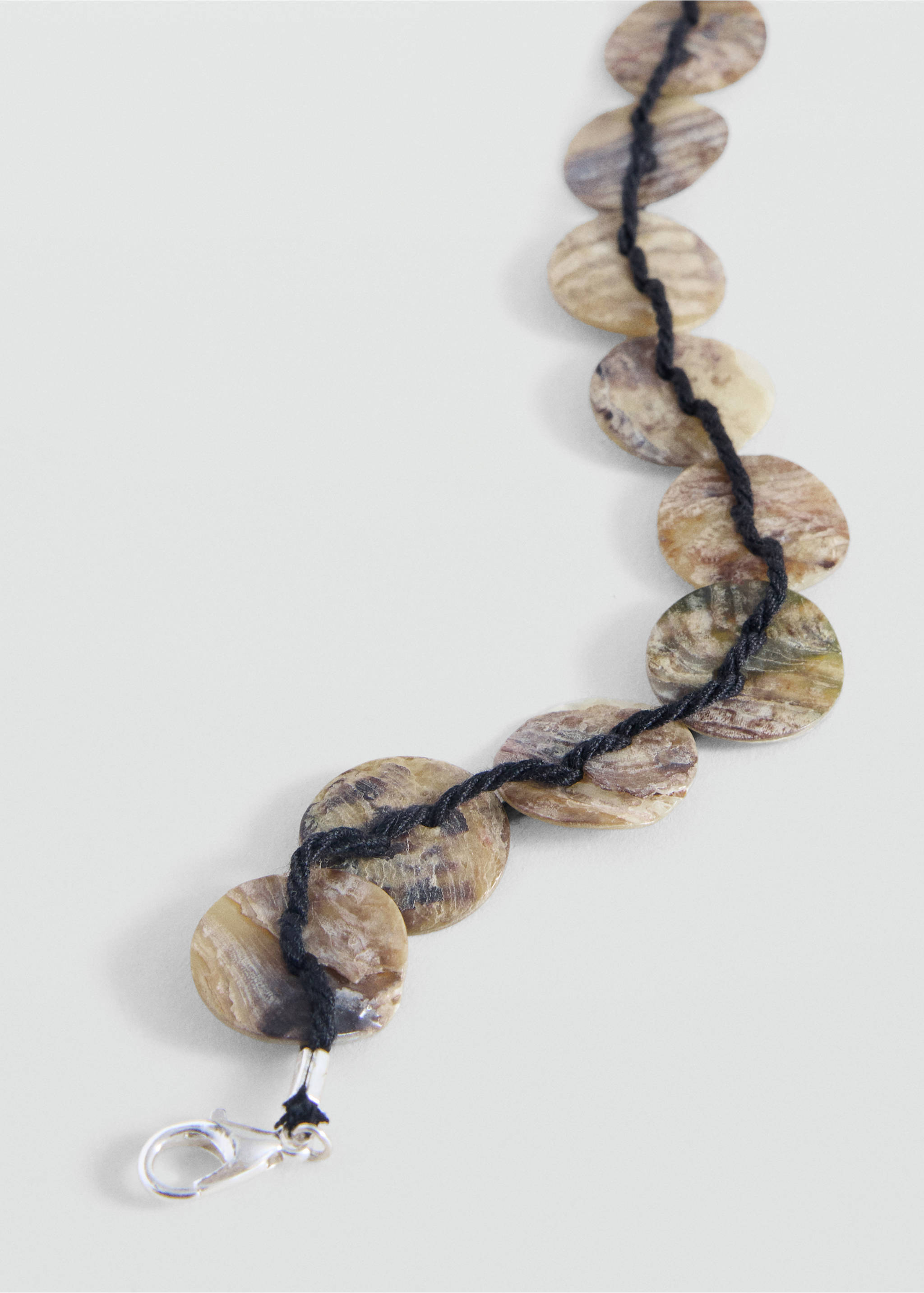Bracelet with circular mottled discs threaded on a black cord., Silver. Ref: 37095176-00.