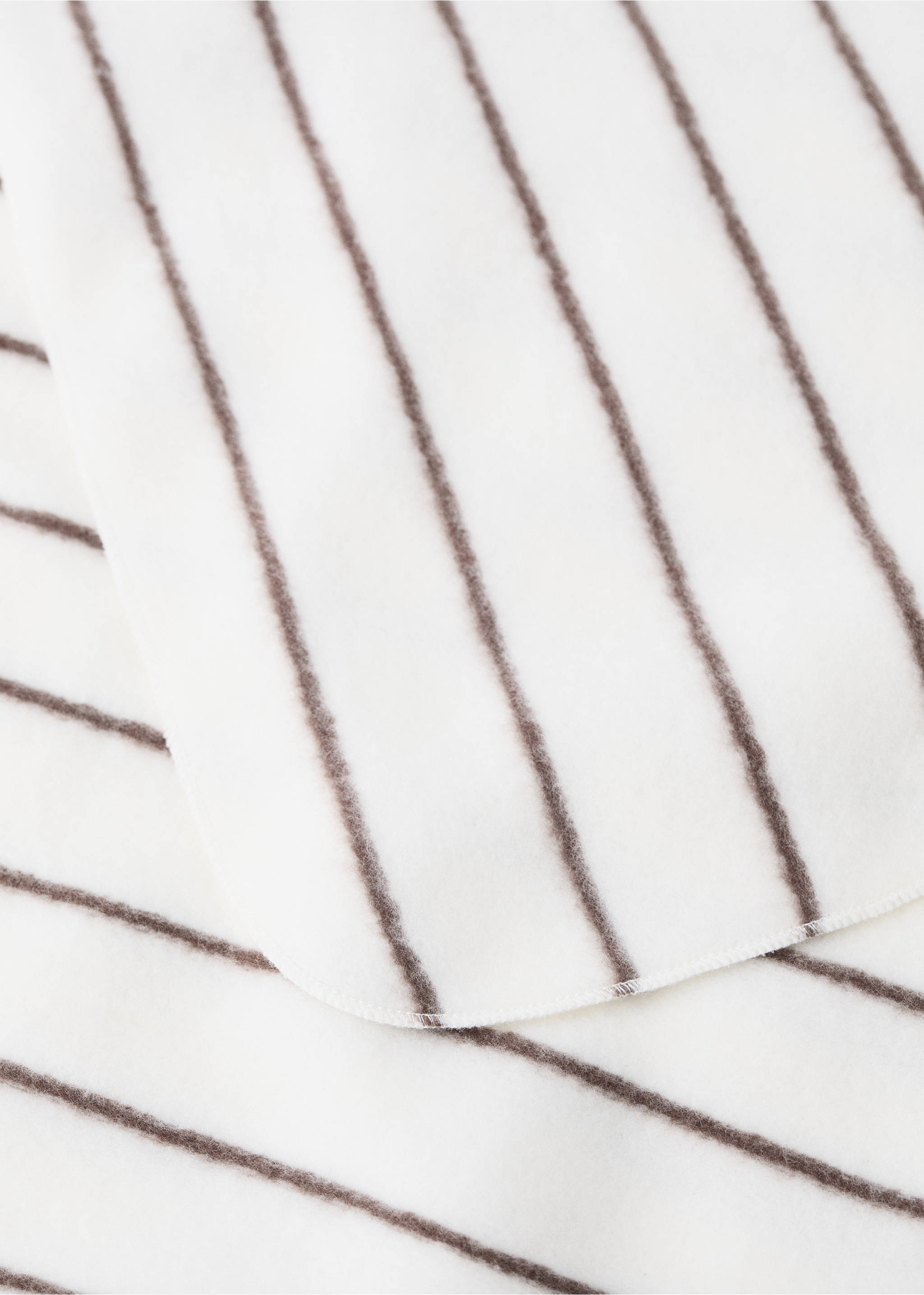 Close-up of a soft white blanket with dark brown vertical stripes., Medium Brown. Ref: 37095180-00.